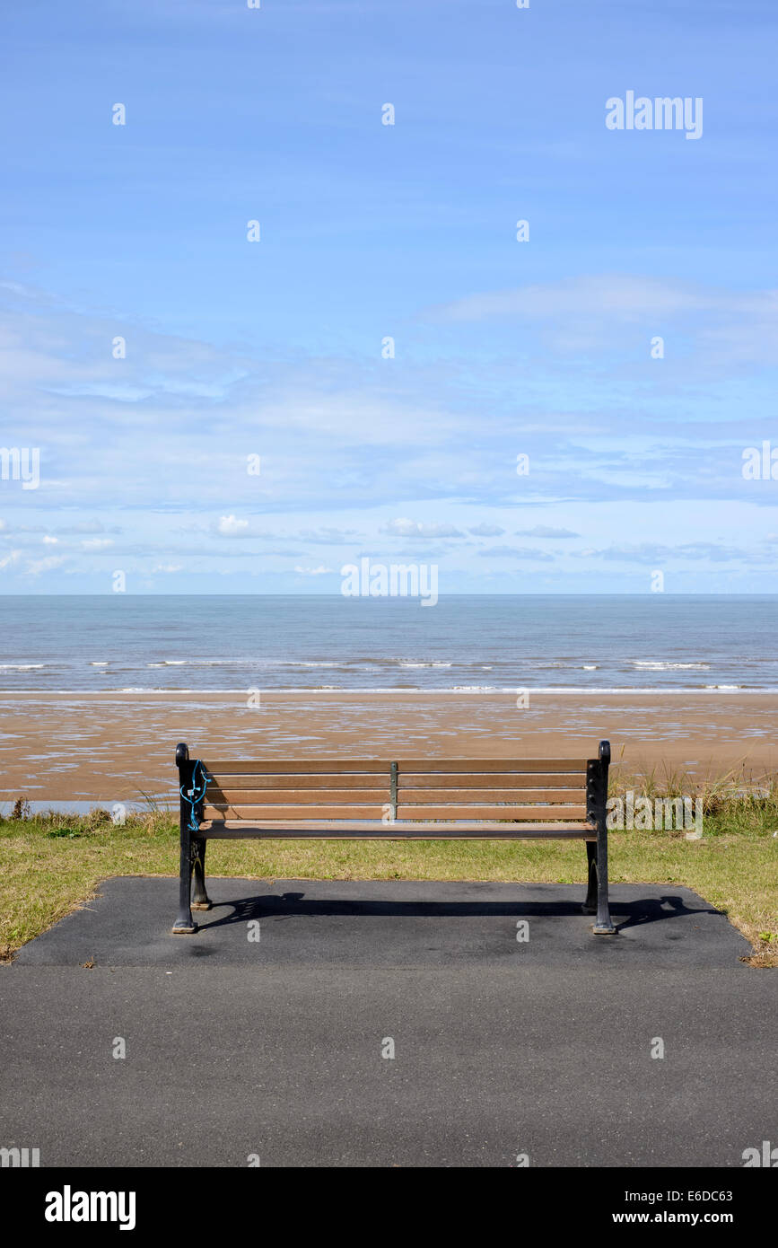 Empty wooden bench on seafront in Blackpool, Lancashire, England Stock Photo