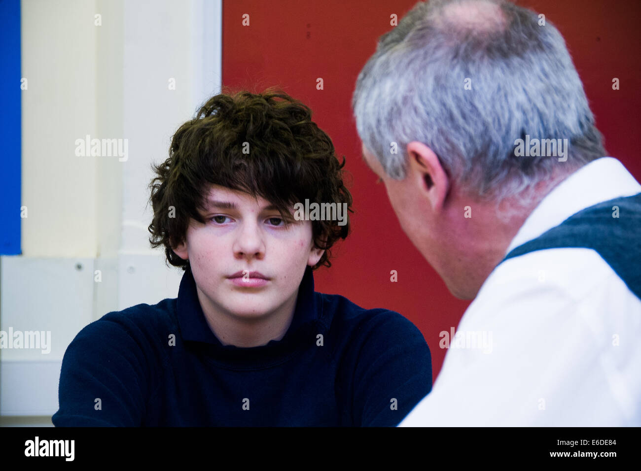 Boy being told off by teacher at Secondary School in UK Stock Photo