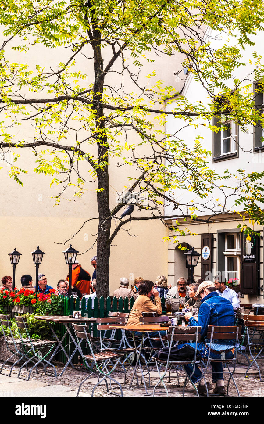 People enjoying a drink at an outdoor cafe in the Nicholas Quarter of Berlin. Stock Photo