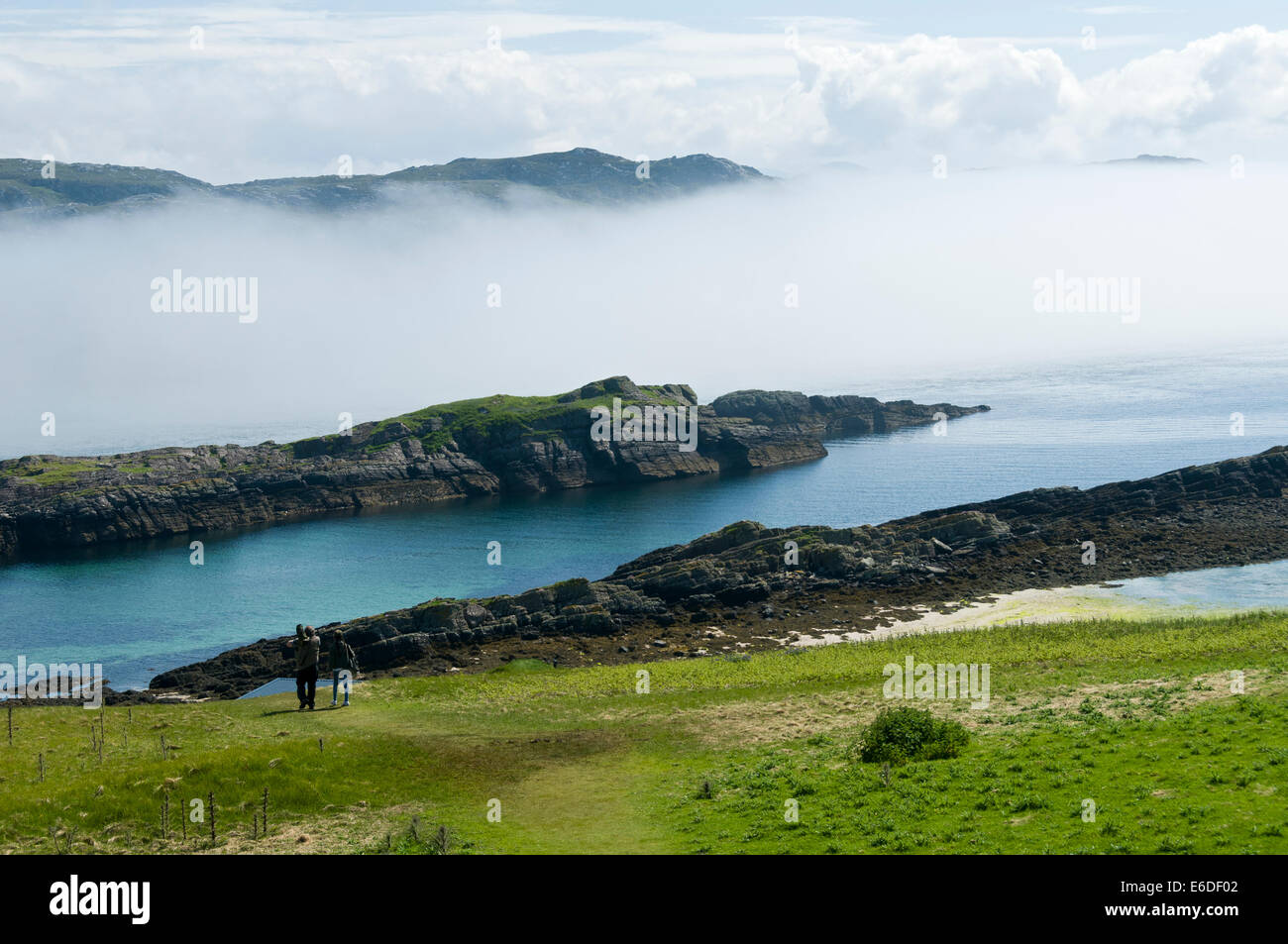 Sea fog near the southern tip of Handa Island with the mainland beyond, Sutherland, Scotland, UK Stock Photo