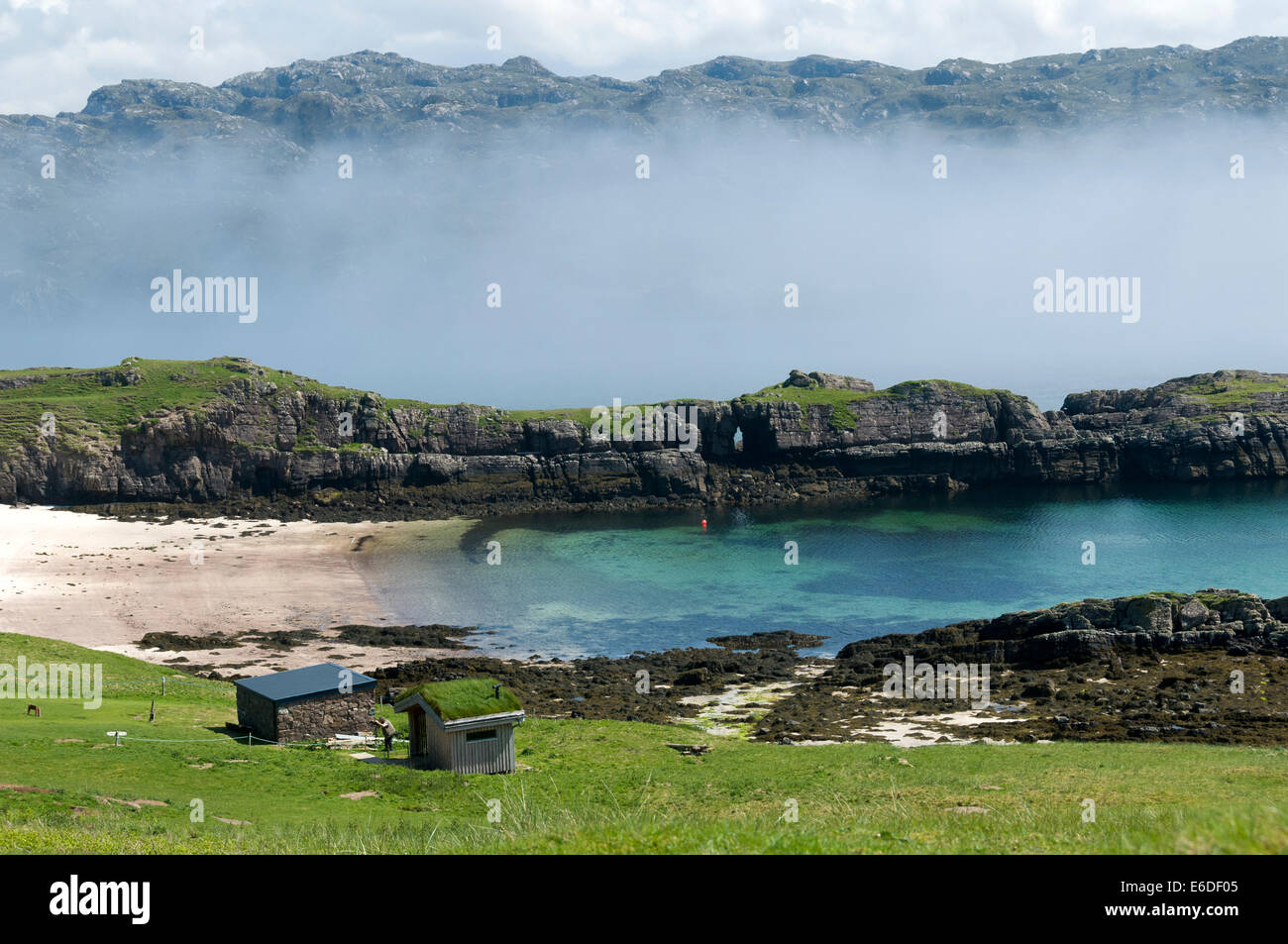 Beach and sea fog near the southern tip of Handa Island with the mainland beyond, Sutherland, Scotland, UK Stock Photo