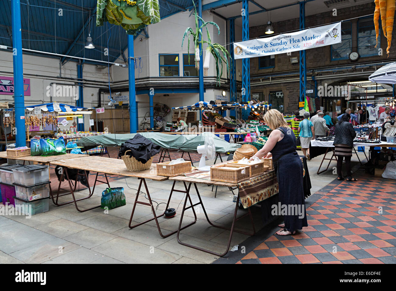 Market traders packing away stalls in indoor market, Abergavenny, Wales, UK Stock Photo