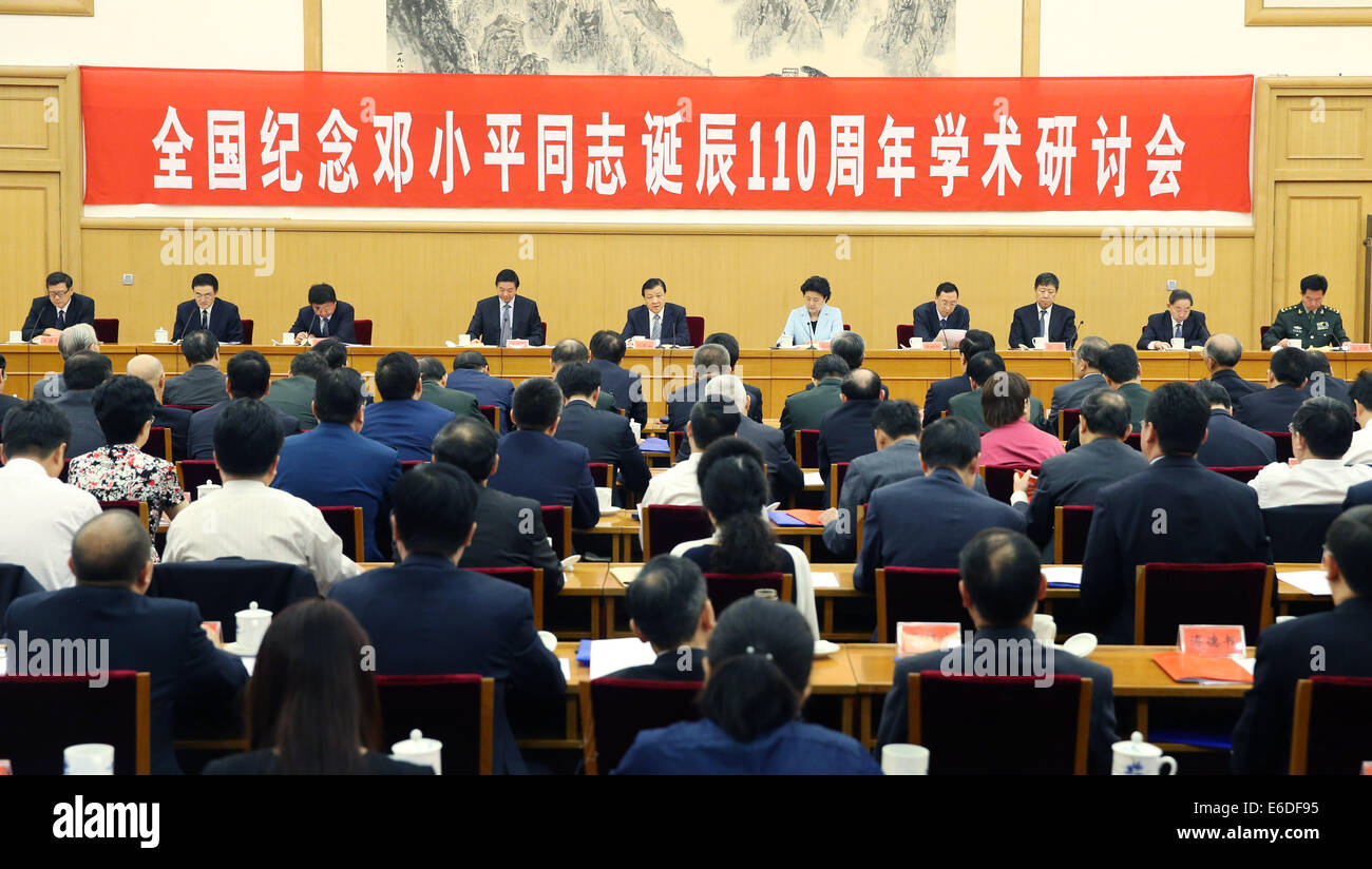 Beijing, China. 21st Aug, 2014. Liu Yunshan (C), a member of the Standing Committee of the Political Bureau of the Communist Party of China (CPC) Central Committee and secretary of the Secretariat of the CPC Central Committee, addresses a symposium to mark the upcoming 110th anniversary of the birth of late Chinese leader Deng Xiaoping, which falls on Friday, in Beijing, capital of China, Aug. 21, 2014. Deng was born on Aug. 22, 1904 in southwest China's Sichuan Province. © Xinhua/Alamy Live News Stock Photo