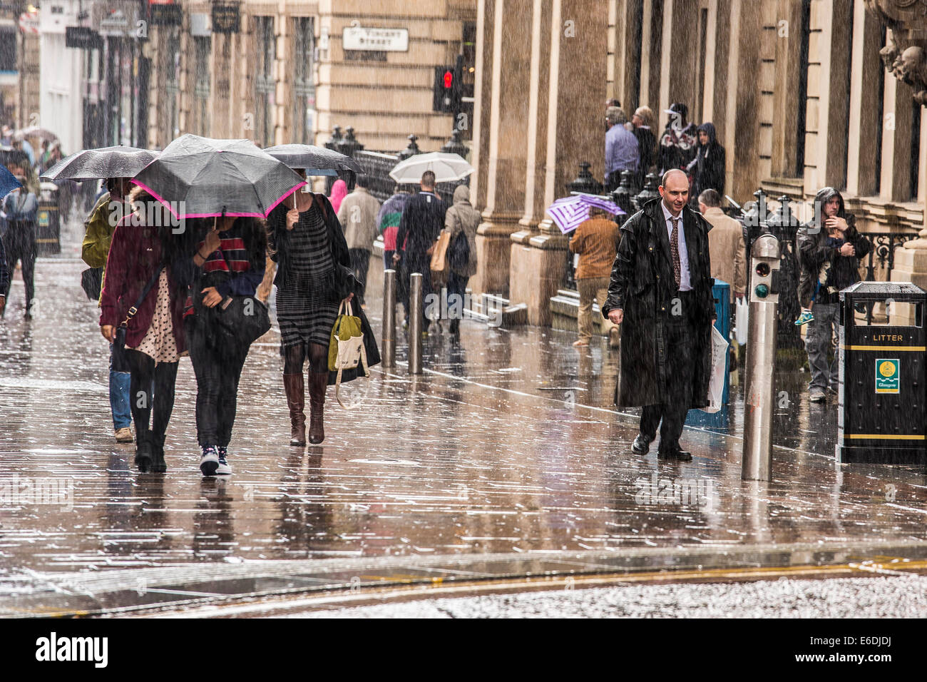 Many people get soaked as torrential rain lashes down during a ...
