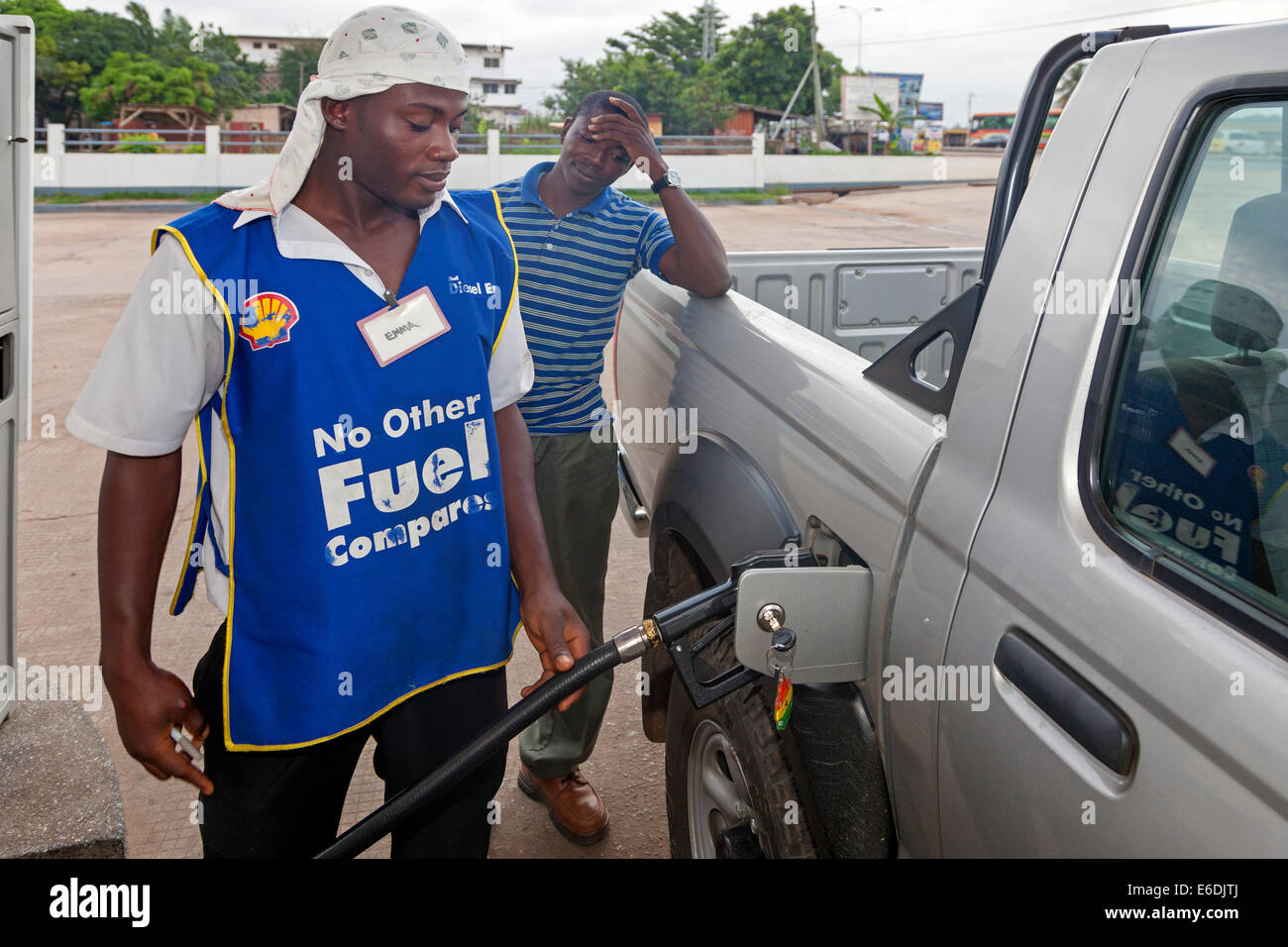 People filling up a vehicle at a petrol filling station, Accra, Ghana