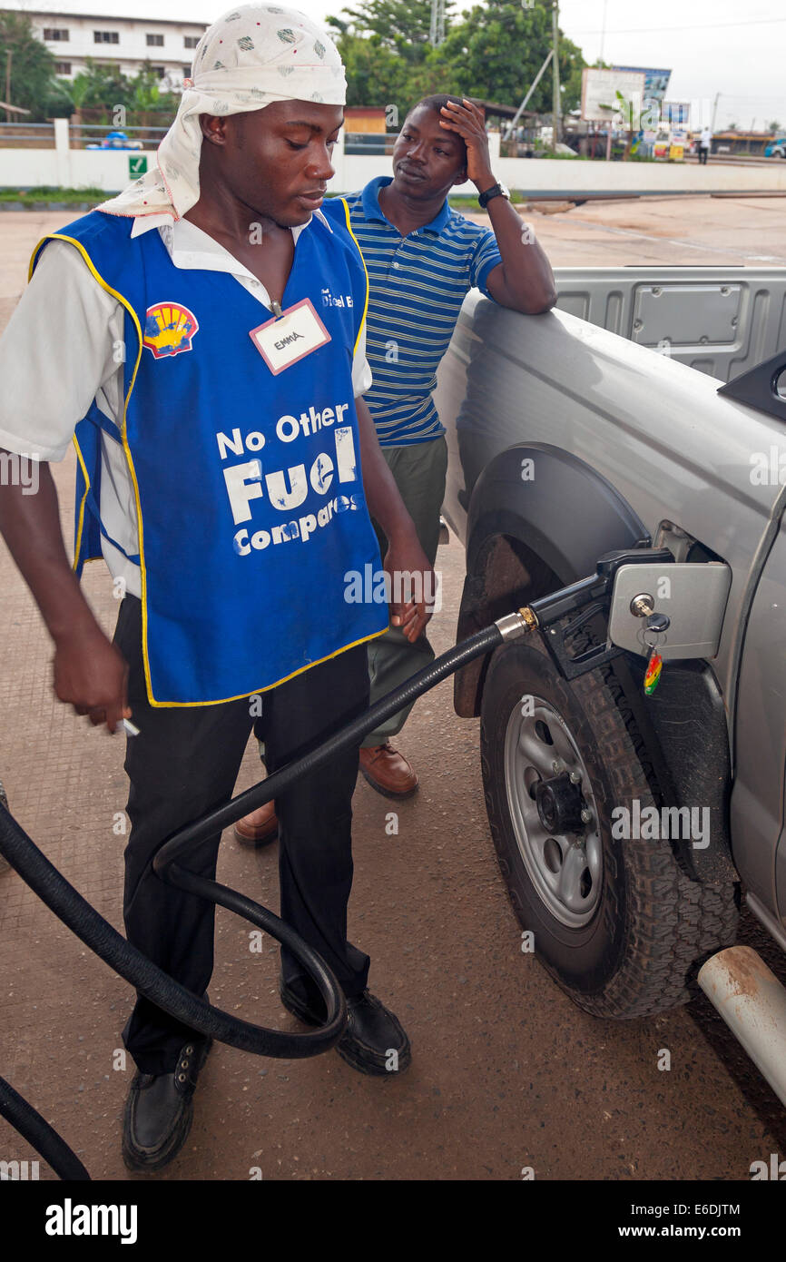 Customer and staff at a petrol filling station, Accra, Ghana, Africa