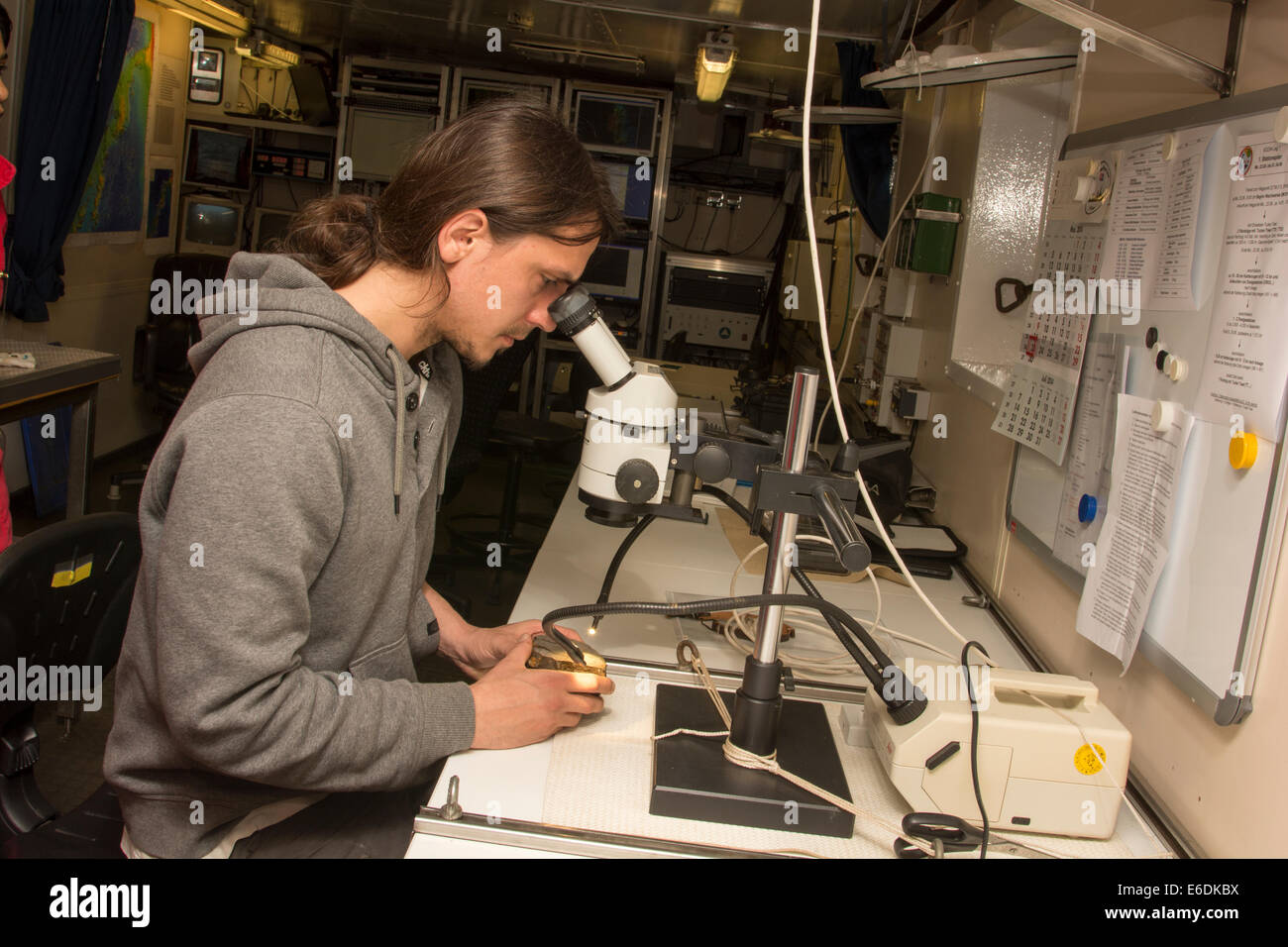 After dredging stones from submarine slopes of old volcanoes Geomar geologist Stephan Homrighausen is analyzing some samples. Stock Photo