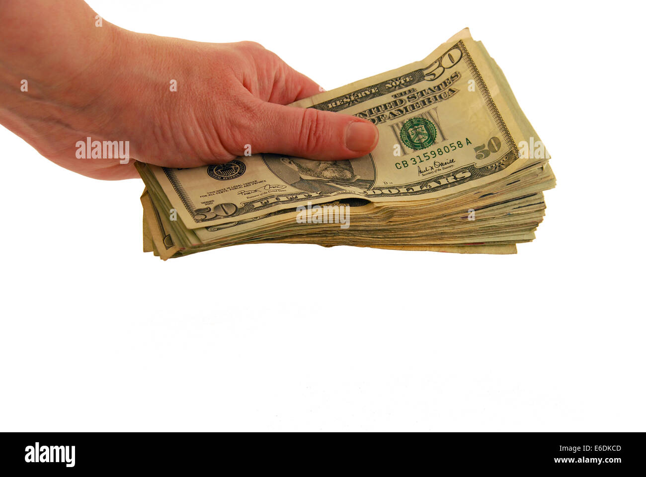 Money in hand in the form of many large bills Stock Photo