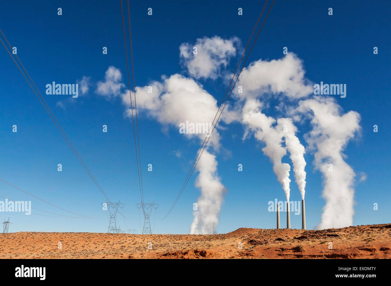 Power industry infrastructure. Chimneys with white smoke on a blue sky, USA. Stock Photo