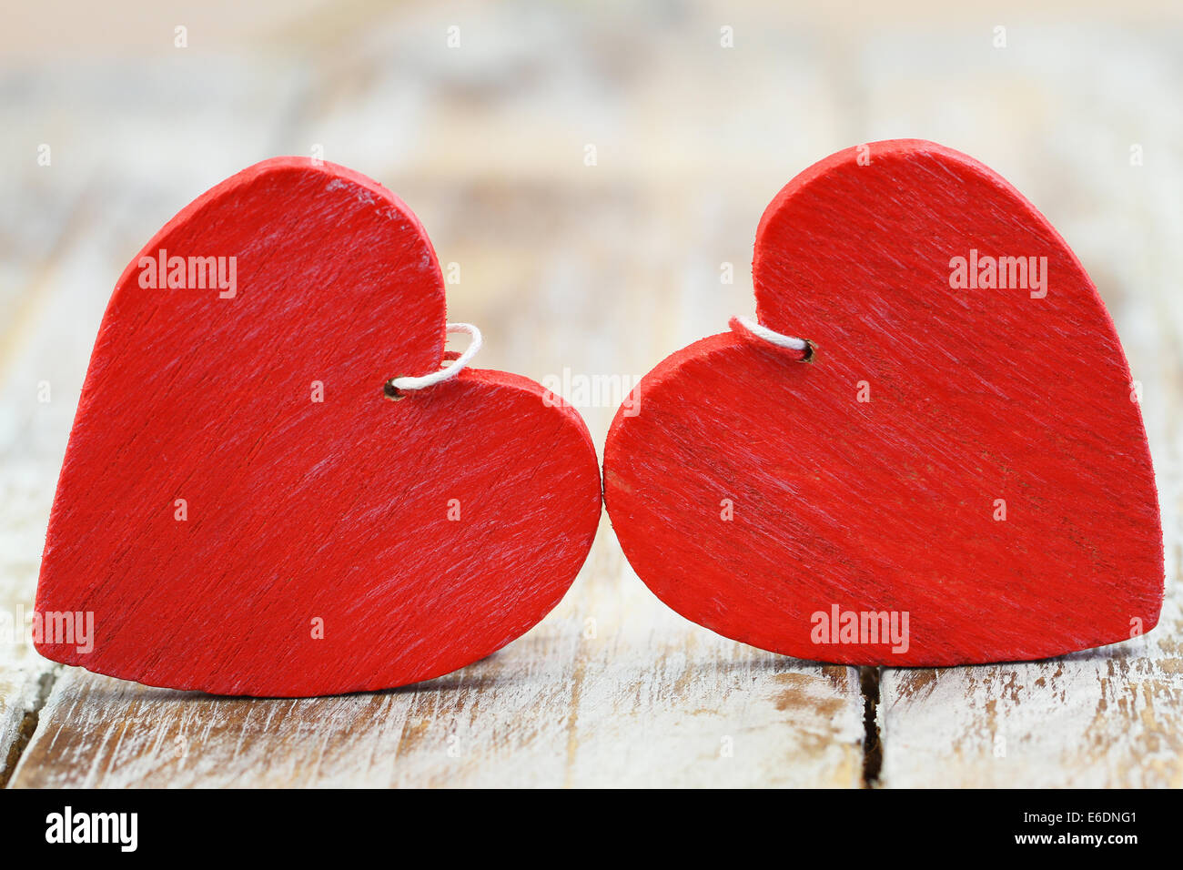 Two red wooden hearts on wooden surface Stock Photo