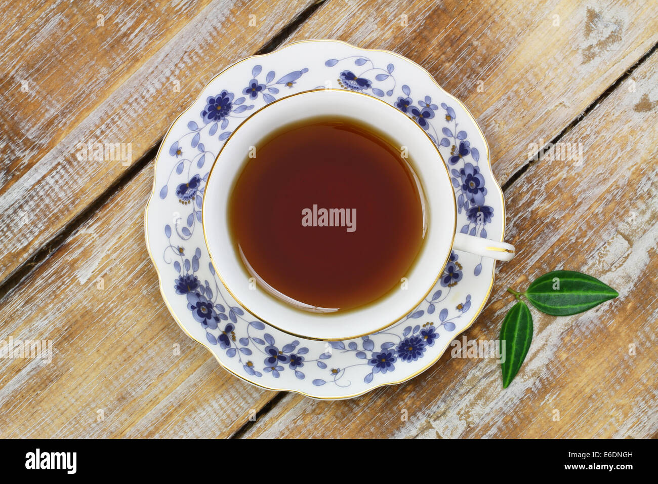Tea in vintage cup on wooden surface Stock Photo