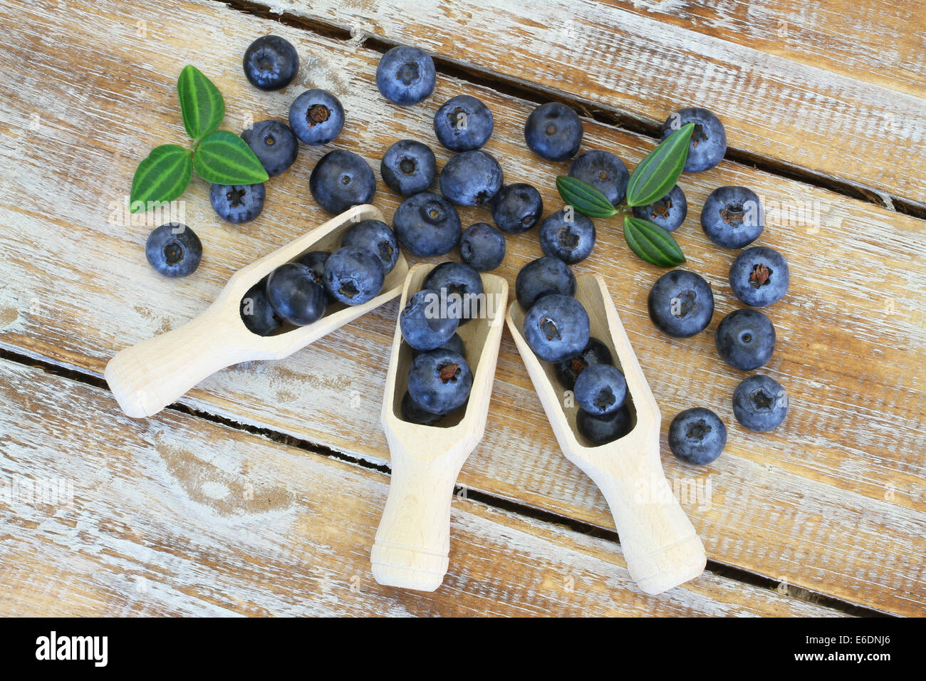 Blueberries on wooden scoops on wooden surface Stock Photo