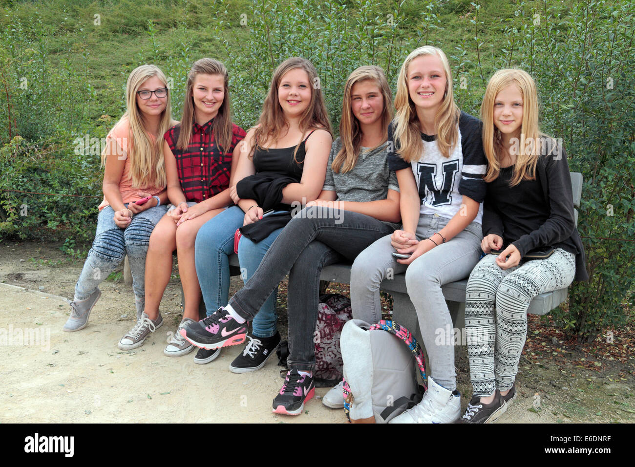 A Group Of Six Teenage Girls Sitting On A Park Bench In Neerpelt