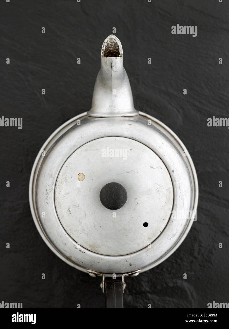 Vintage Metal Teapot on a black slate background Stock Photo