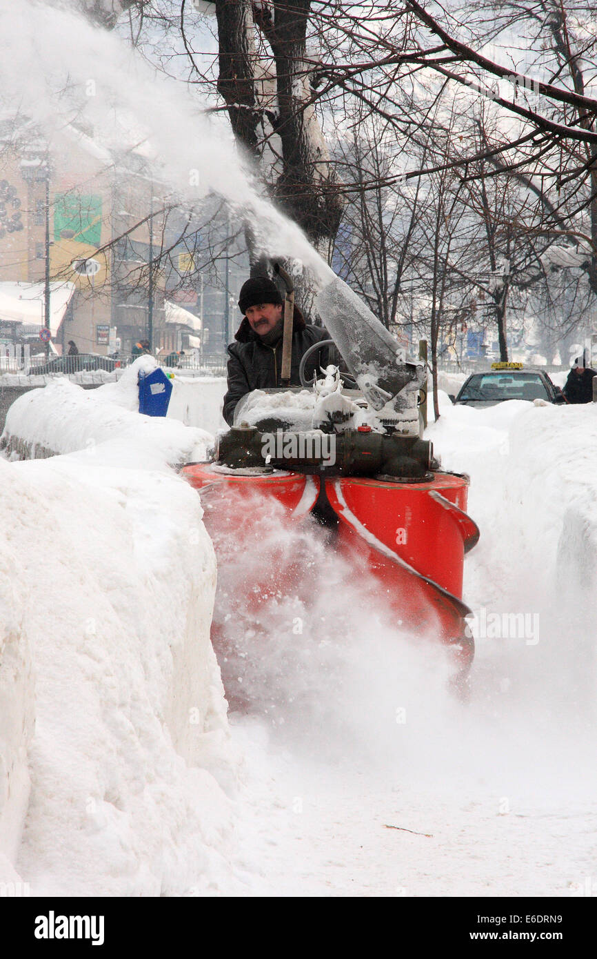 Snow blower clears snow from sidewalks in Sarajevo, Bosnia and Herzegovina days after record-breaking snowfall in February 2012 Stock Photo