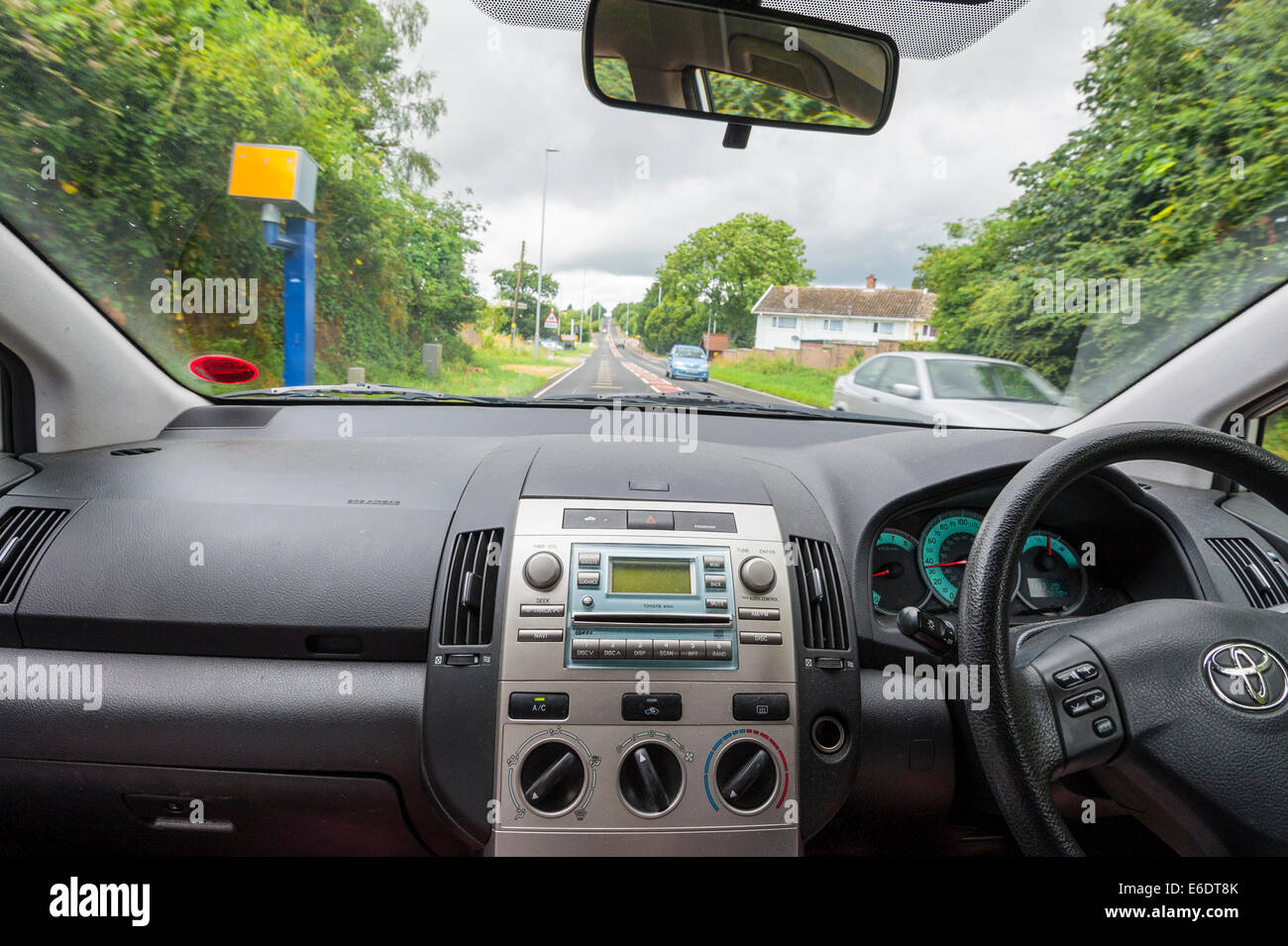 A person driving into a speed camera catch zone shown from the interior of the car in the Uk Stock Photo