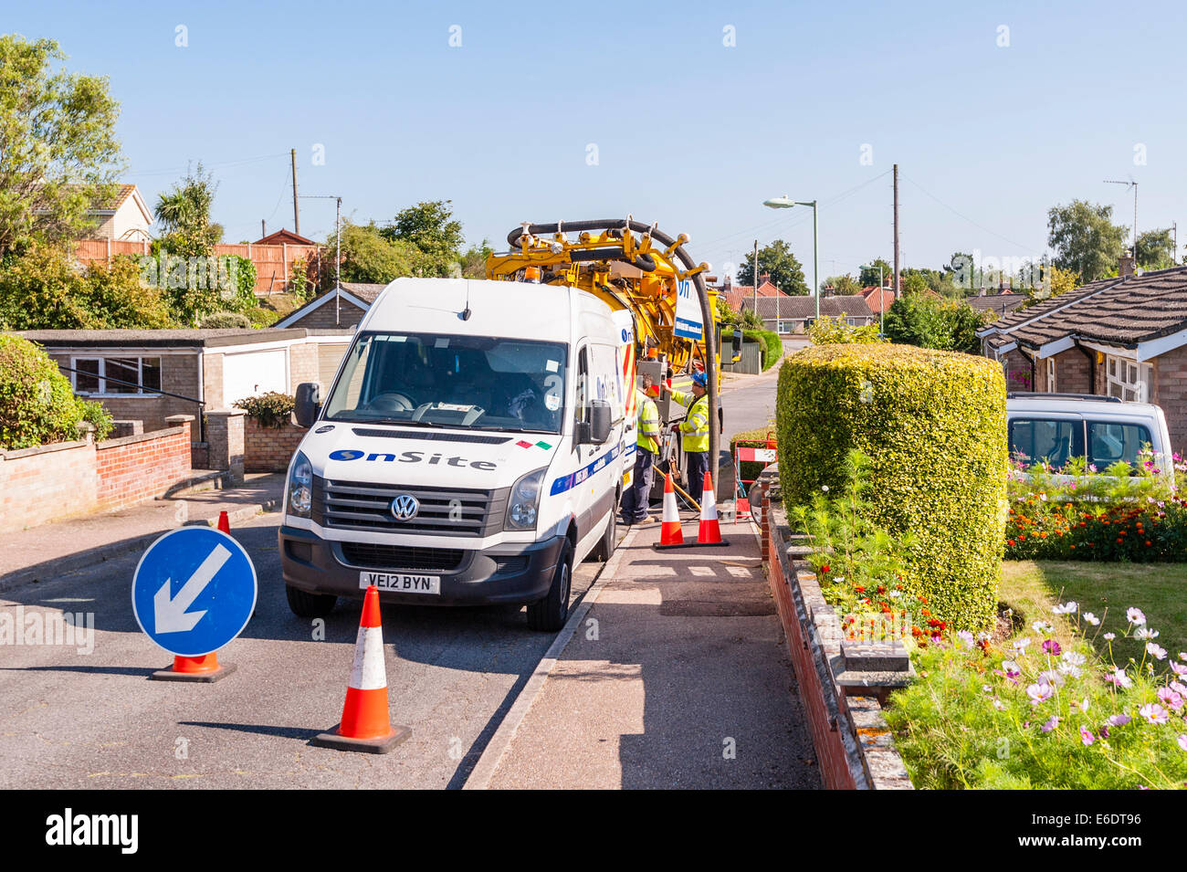 A contracted firm cleaning out the sewer pipes in the road and checking