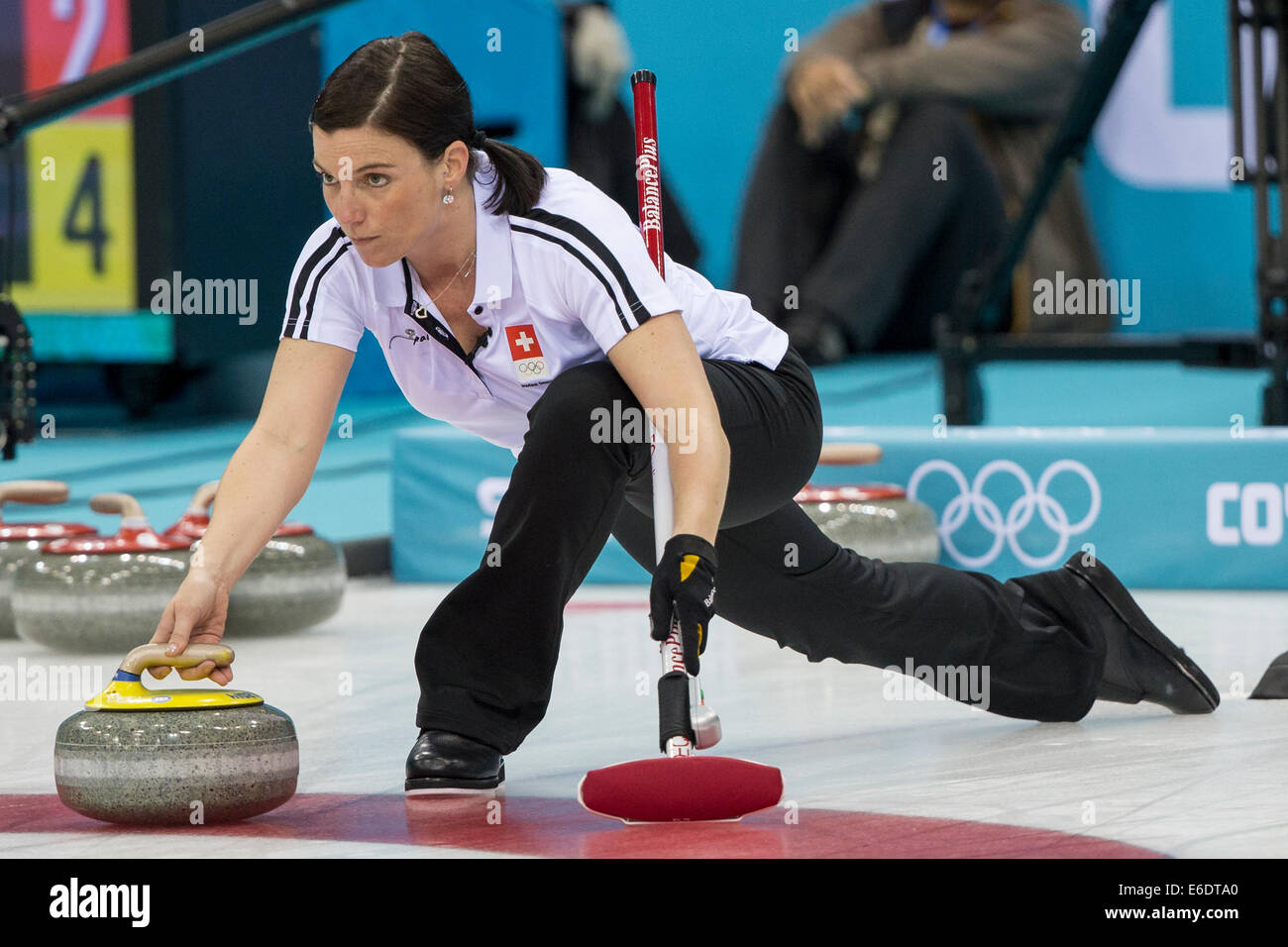Team Swiss, Carmen Kueng  plays a stone during  Women's curling competition at the Olympic Winter Games, Sochi 2014 Stock Photo