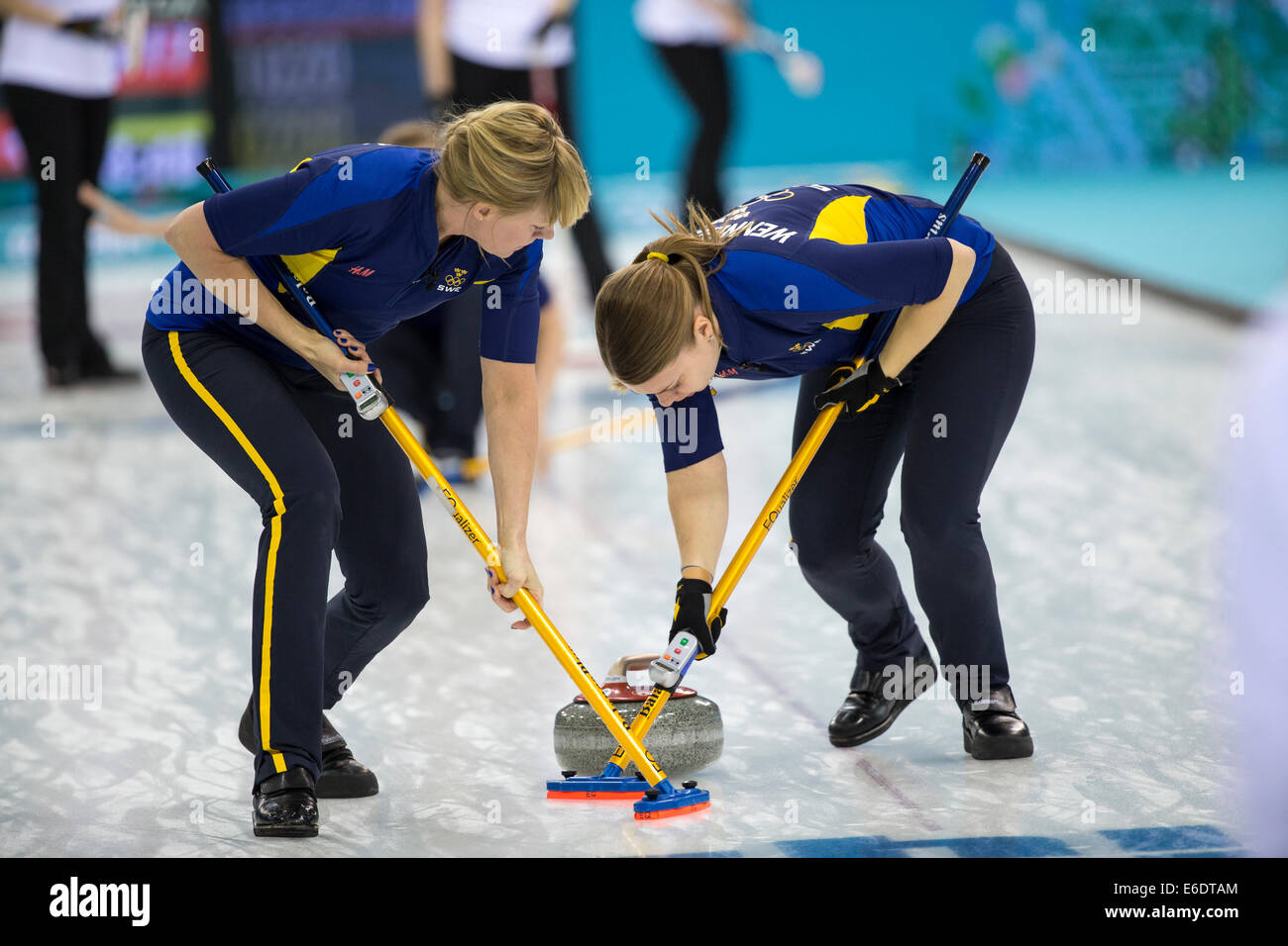 Maria Prytz (L) and Maria Wennerstroem of Team Sweden sweeping during Women's curling