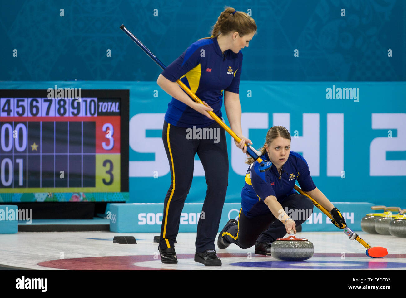 Maria Wennerstroem plays a stone with (Christina Bertrup sweeping  of Team Sweden during  Women's curling competition at the Oly Stock Photo