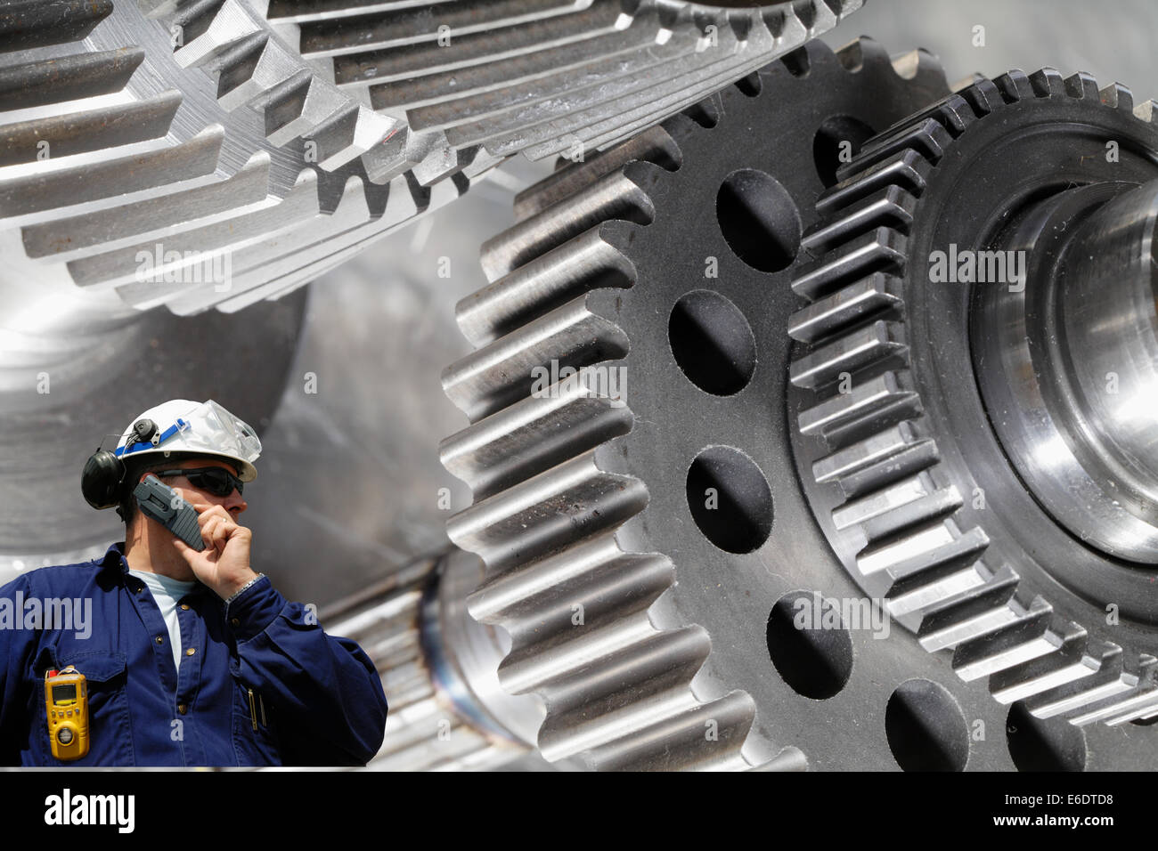 mechanic, worker with giant cogwheels Stock Photo