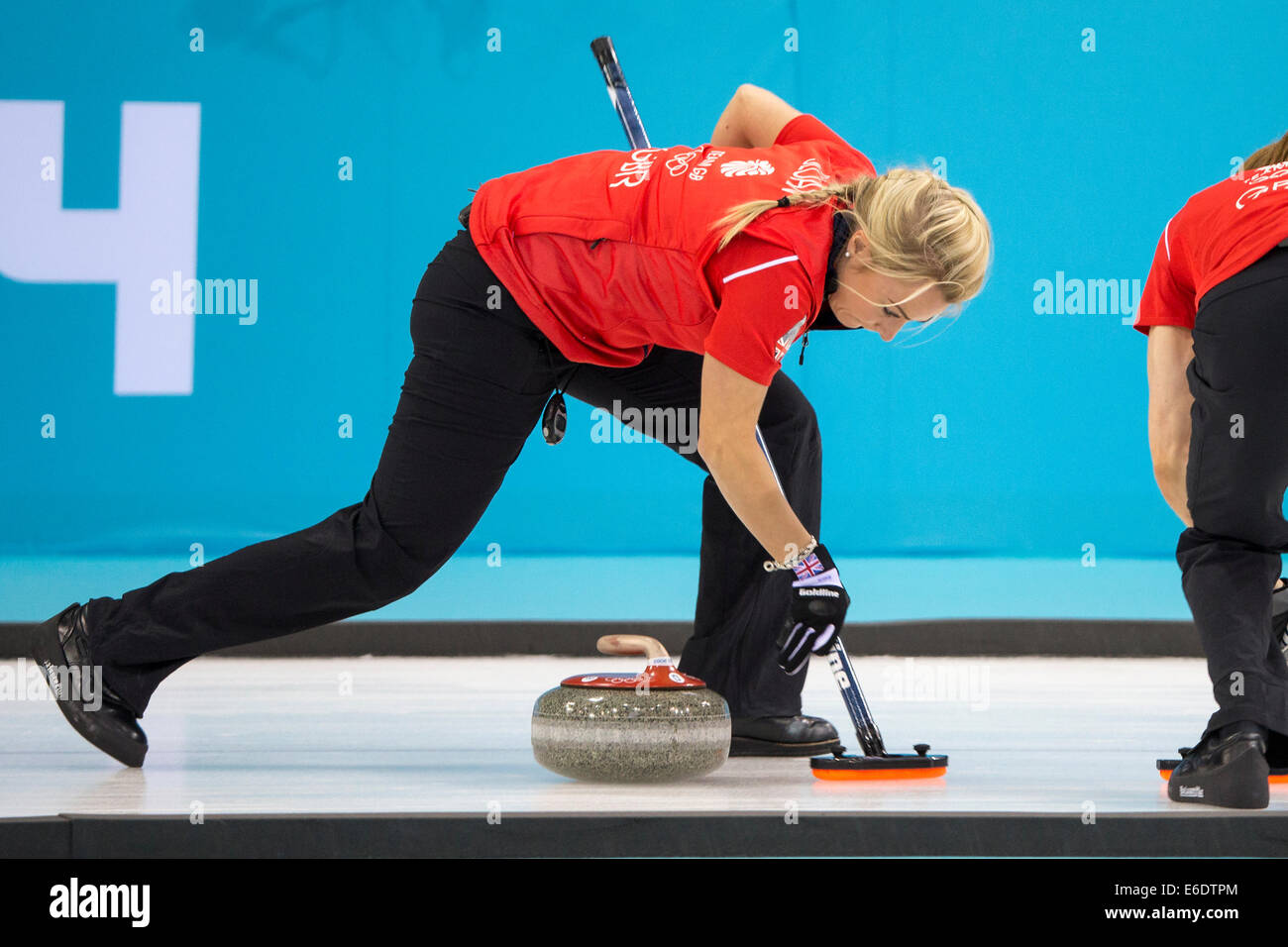 Anna Sloan (C) of Team Great Britain sweeping during Women's curling competition at the Olympic