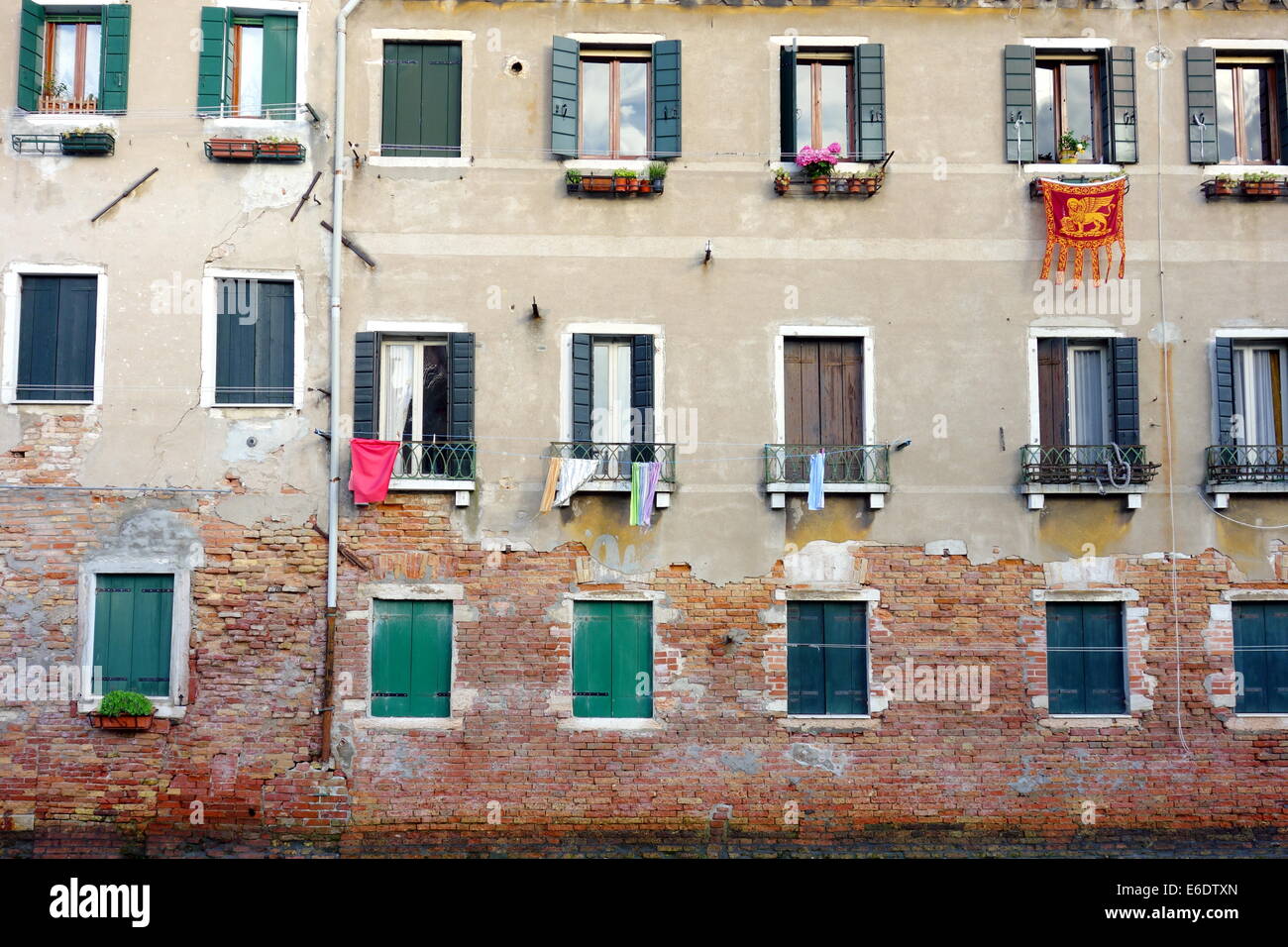Old Venetian building facade on a canal in Venice, Italy Stock Photo