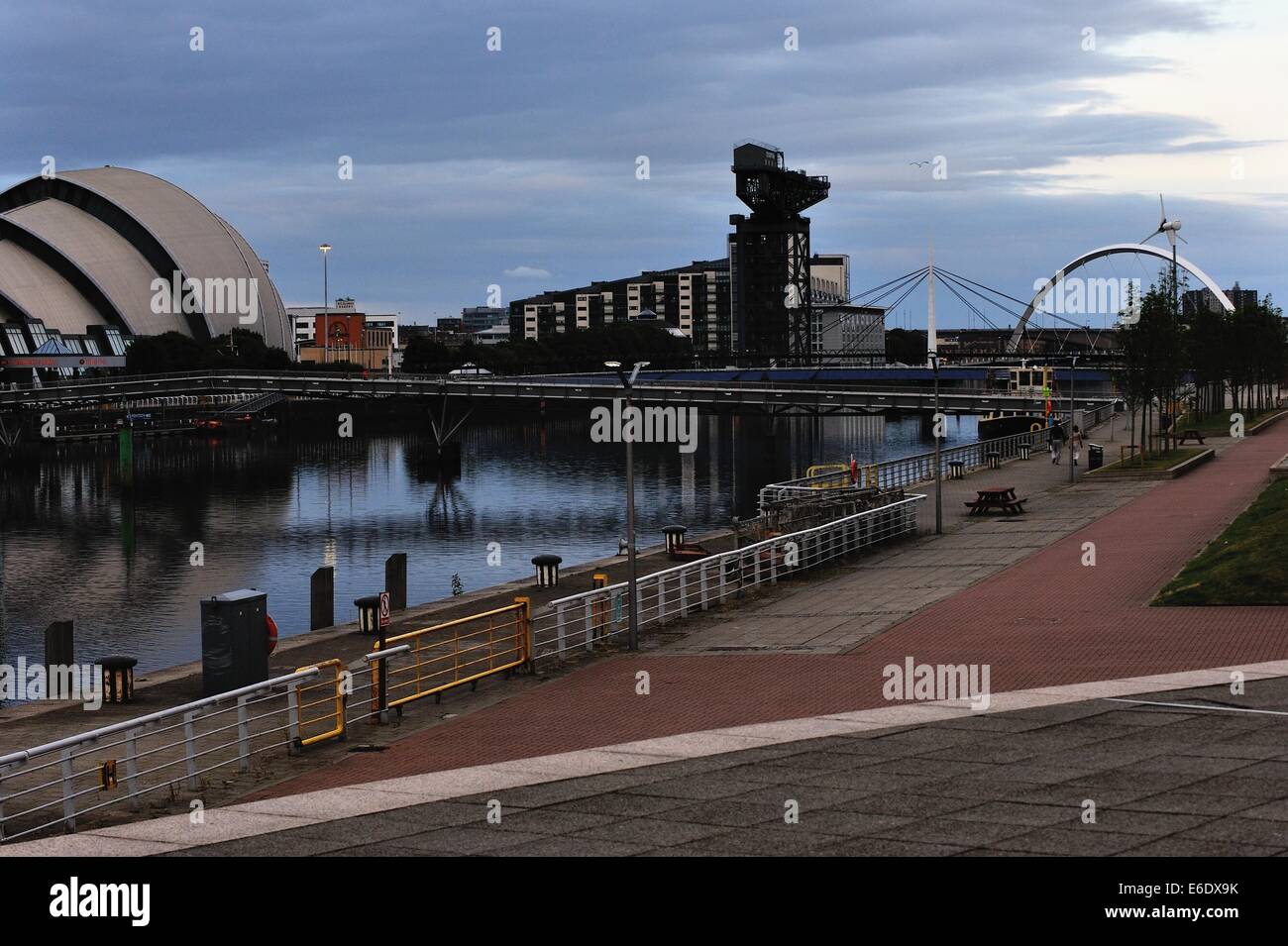 The SECC (Armadillo) and Finnieston Crane and Clyde Arc (Squinty Bridge). reflected in the River Clyde as night falls. Stock Photo