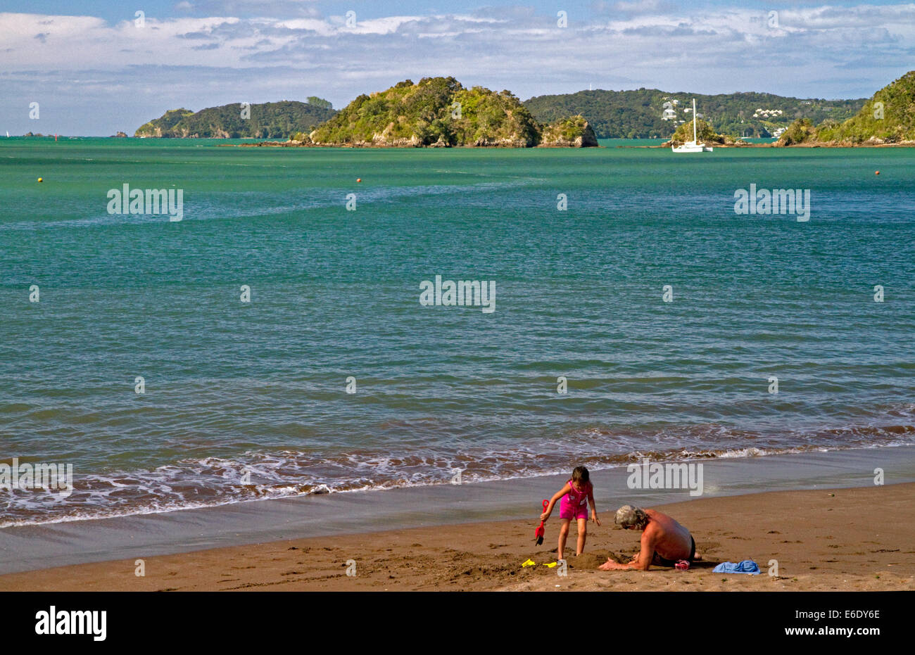 People on the beach at Bay of Islands at the town of Paihia, North Island, New Zealand. Stock Photo