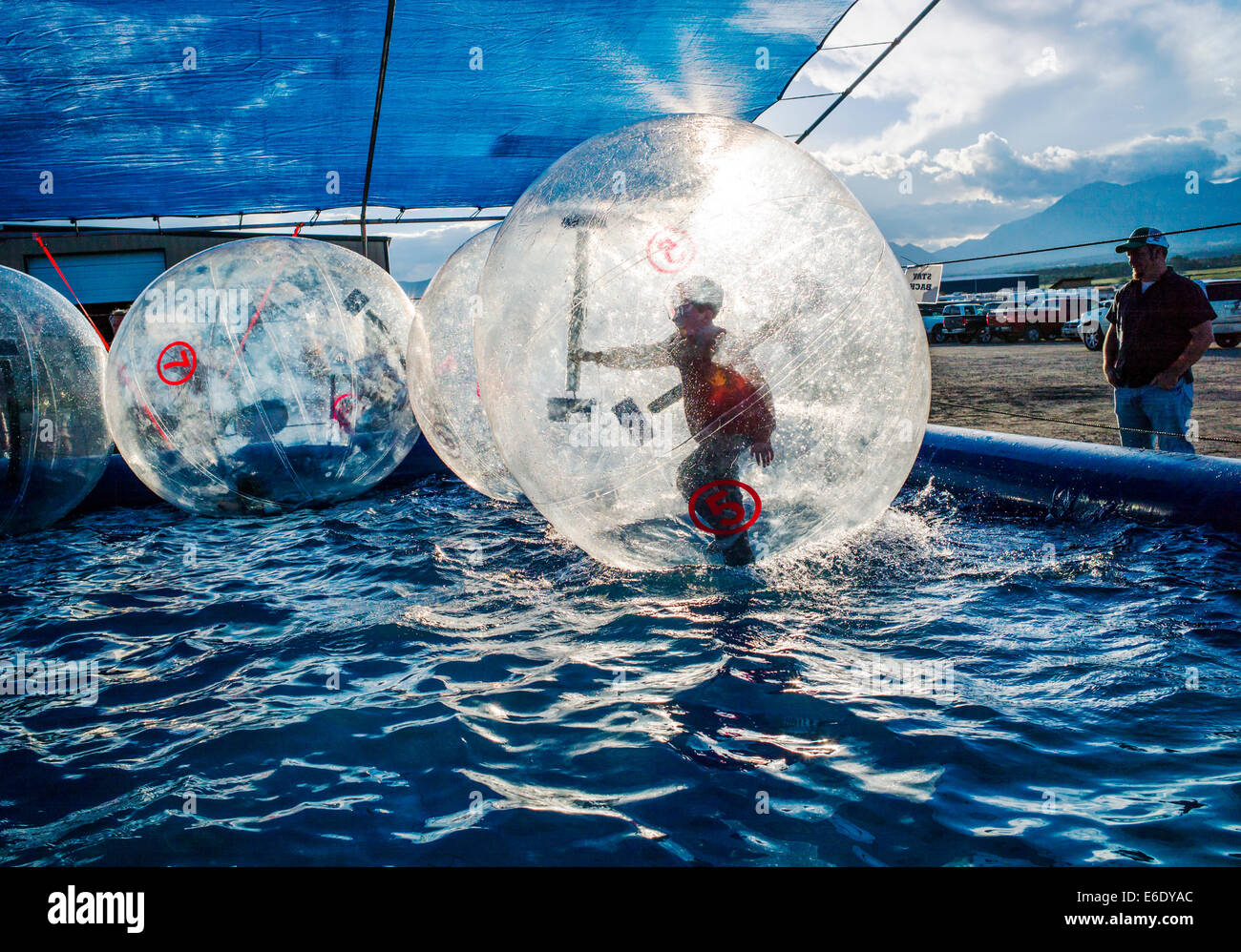 Children play in Water Bubbles, large inflated balls floating in a pool