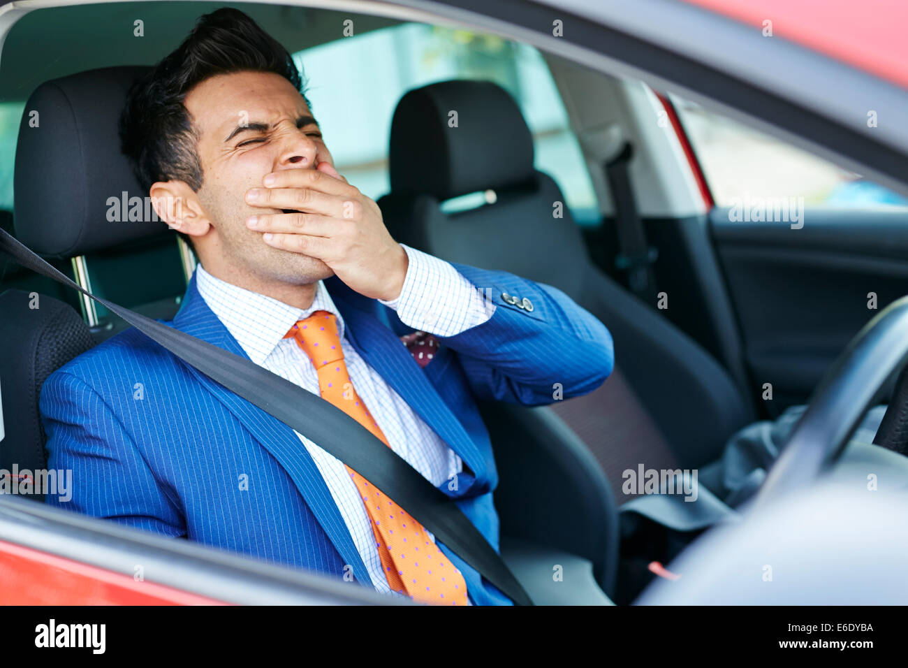 Tired man driving car Stock Photo