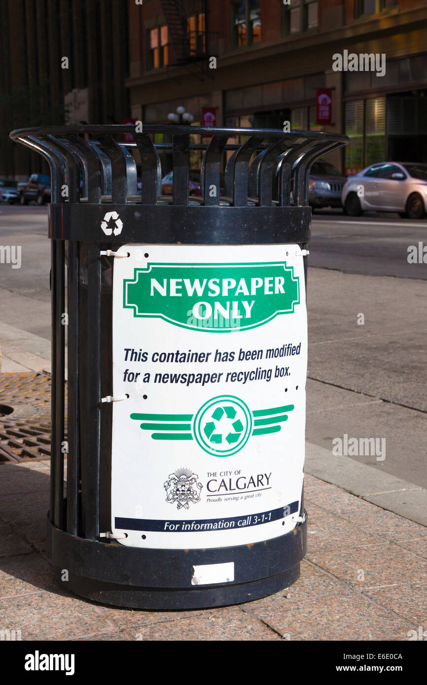 Trash bin modified for newspaper recycling on downtown street Stock Photo