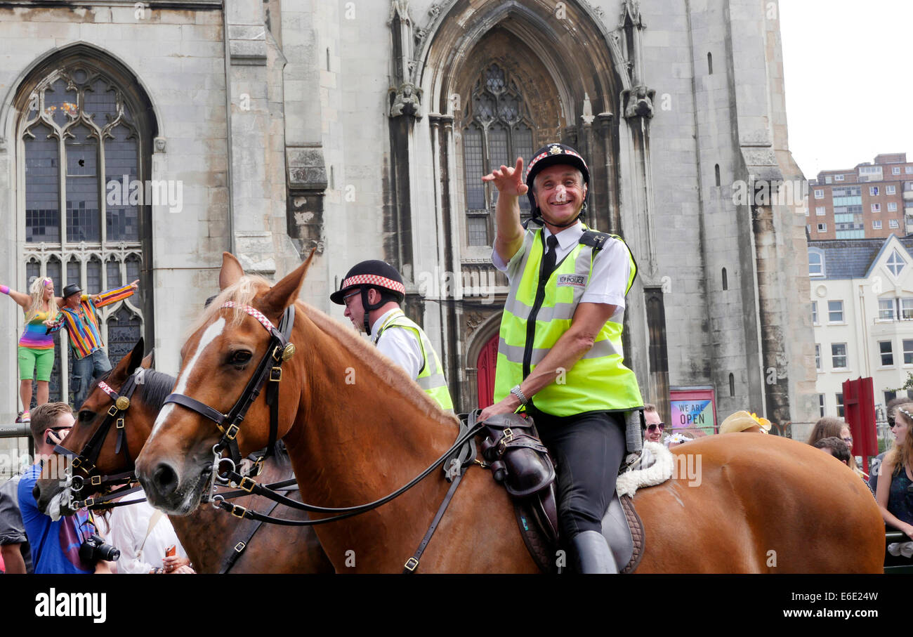 Mounted policeman waving at the Brighton Pride Festival & Parade, Brighton Sussex England Stock Photo