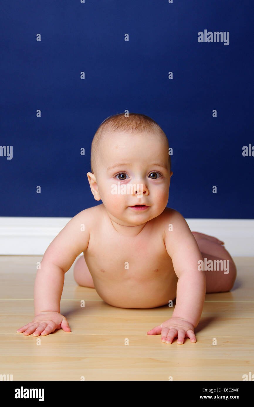9 month old baby boy holding his head up and looking serious Stock Photo