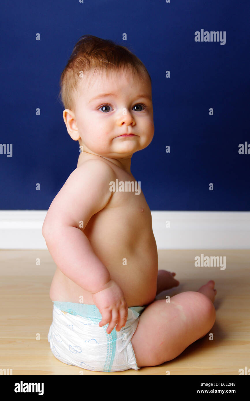 Happy 9 month old baby boy sitting up Stock Photo Alamy