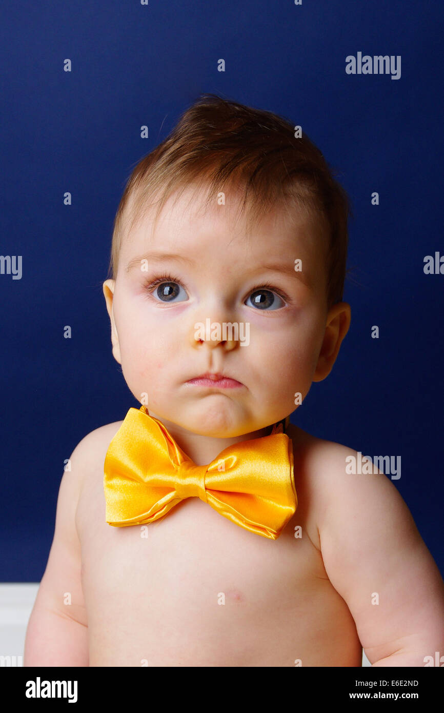 9 month old baby boy in a yellow bow tie Stock Photo