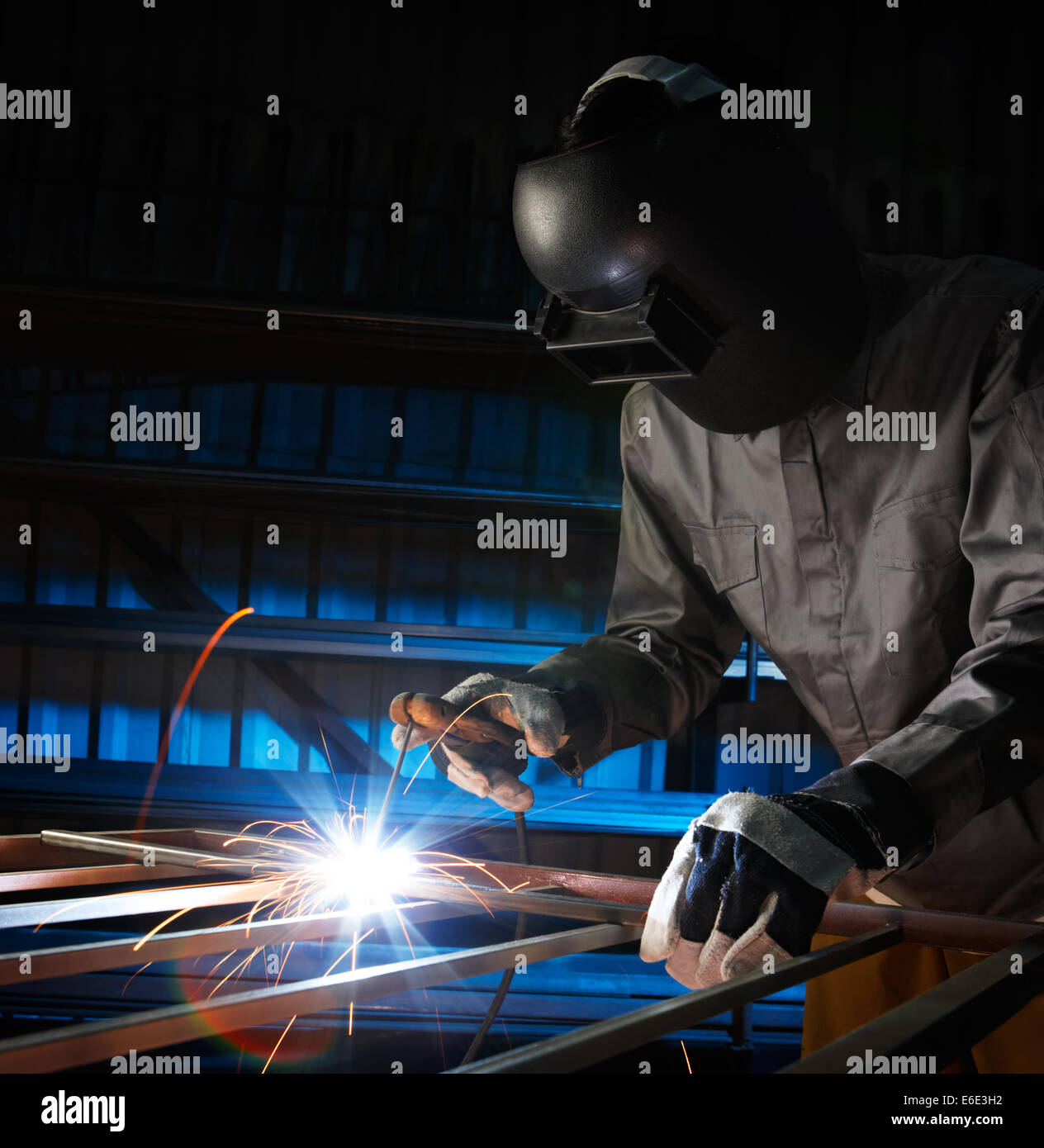 man welding in workshop with safety precaution Stock Photo