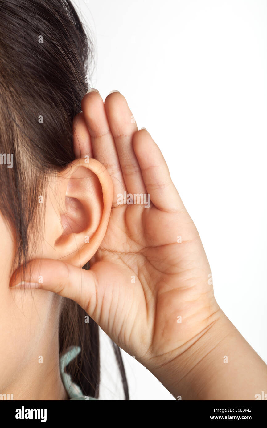 Closeup of an Asian girl cupping ear with her hand Stock Photo
