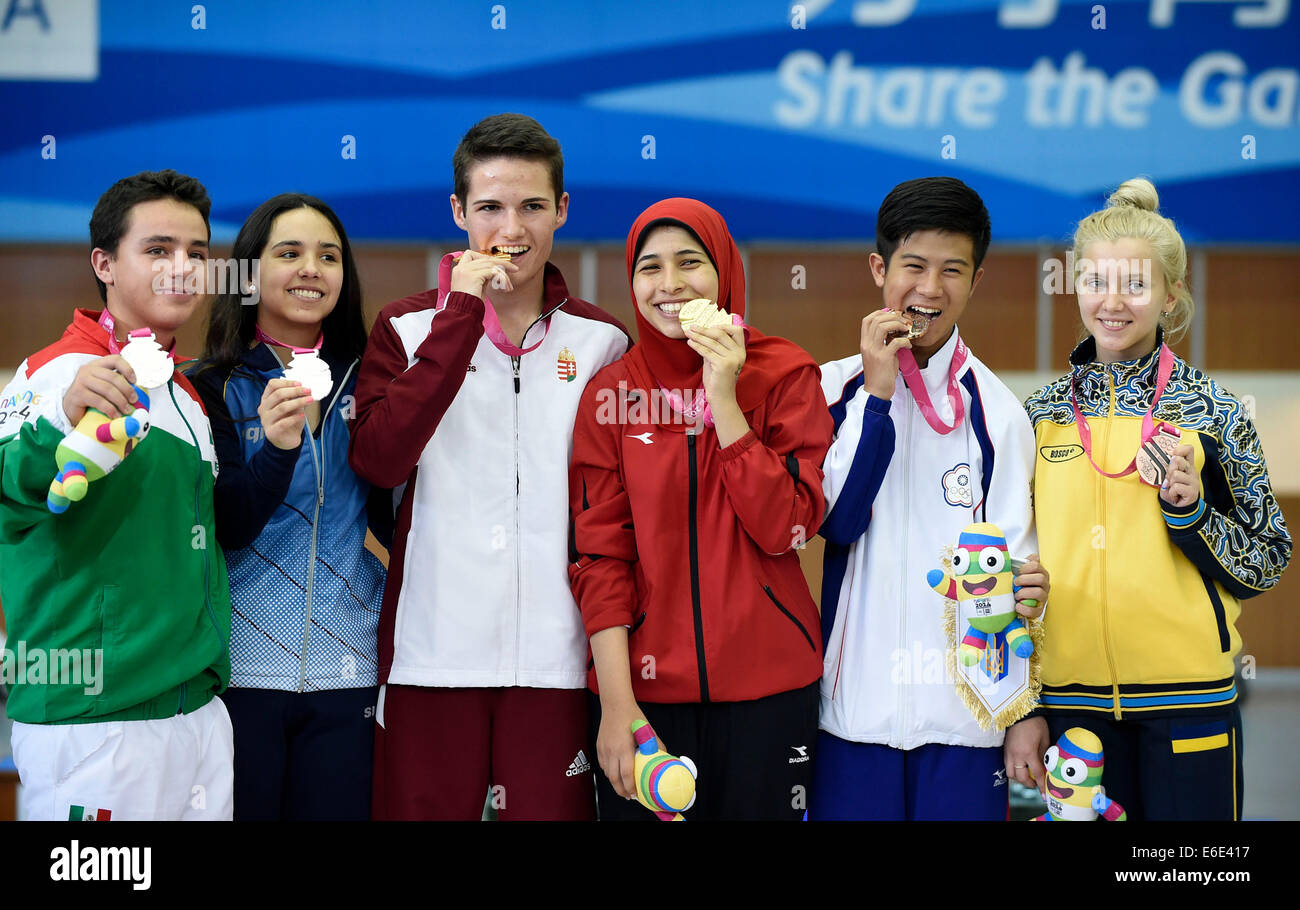 Nanjing, China's Jiangsu Province. 22nd Aug, 2014. Gold medalist Istvan Peni (3rd, L) of Hungary and Hadir Mekhimar (3rd, R) of Egypt, sliver medalist Jose Santos Valdes Martinez (1st, L) of Mexico and Fernanda Russo (2nd, L) of Argentina, bronze medalist Lu Shao-Chuan (2nd, R) of Chinese Taipei and Viktoriya Sukhorukova of Ukraine pose on the podium during the awarding ceremony of the 10m Air Rifle Mixed International Teams Competition at Nanjing 2014 Youth Olympic Games in Nanjing, east China's Jiangsu Province, August 22, 2014. Credit:  Yue Yuewei/Xinhua/Alamy Live News Stock Photo