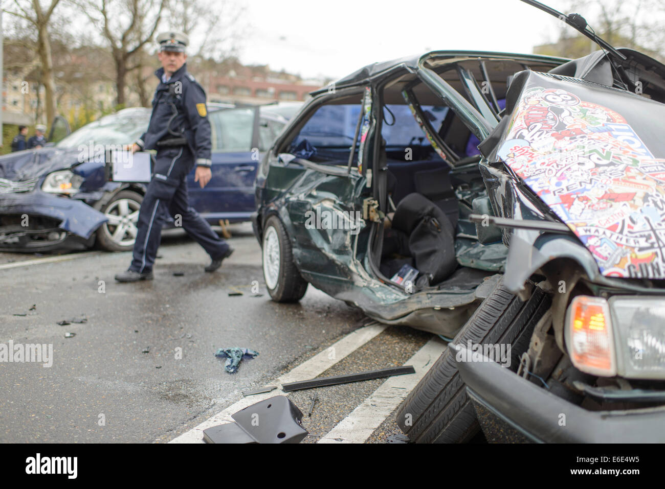 Serious accident, a VW Polo and a VW Touran collided in oncoming traffic,  car wrecks in the street, police officer Stock Photo - Alamy