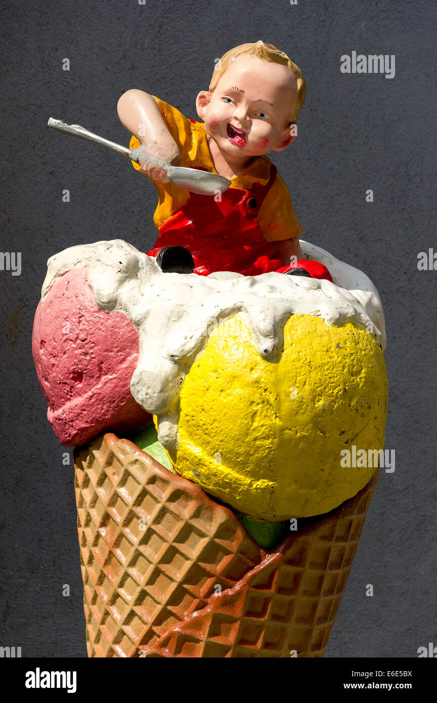 Advertising character in front of an ice cream shop, a young boy in a