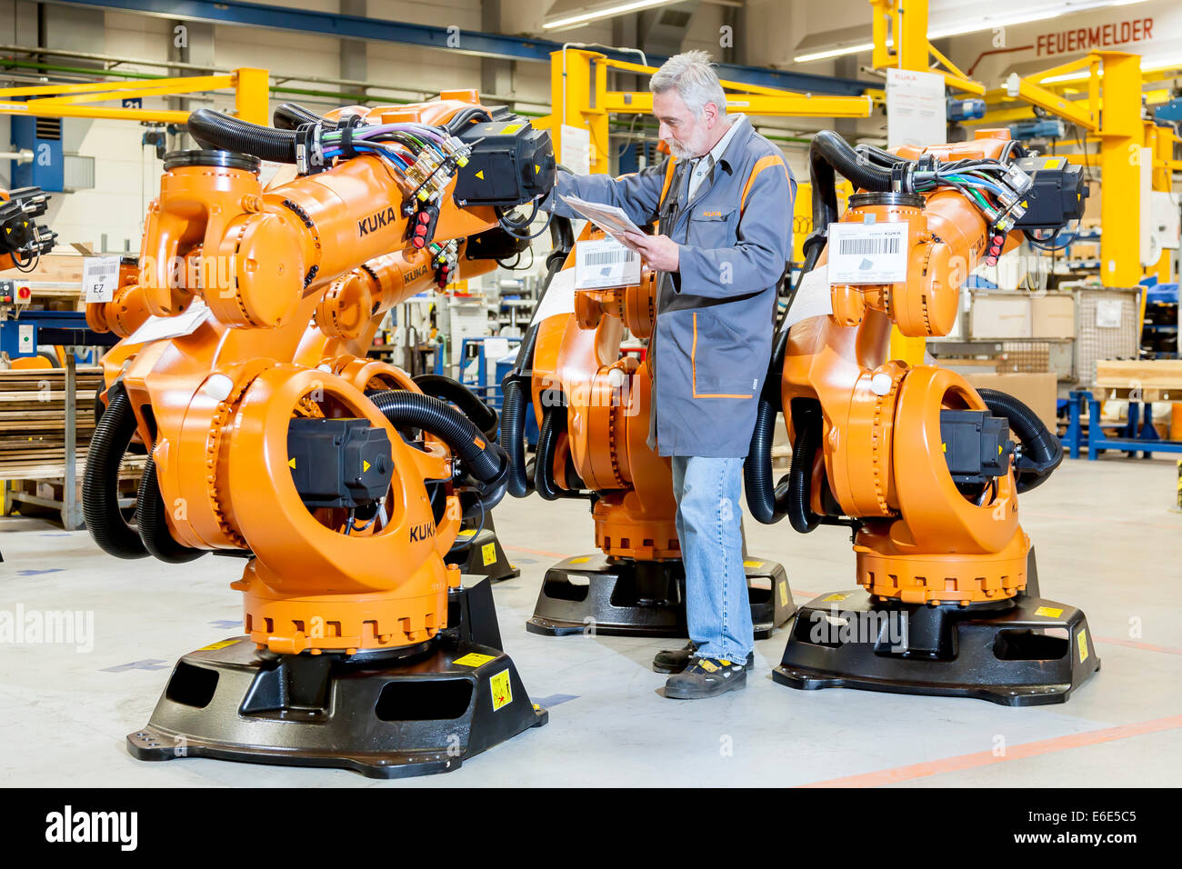 Employee of the robot manufacturer KUKA AG completing the shipping documents before delivery of KUKA robots, Augsburg, Bavaria Stock Photo
