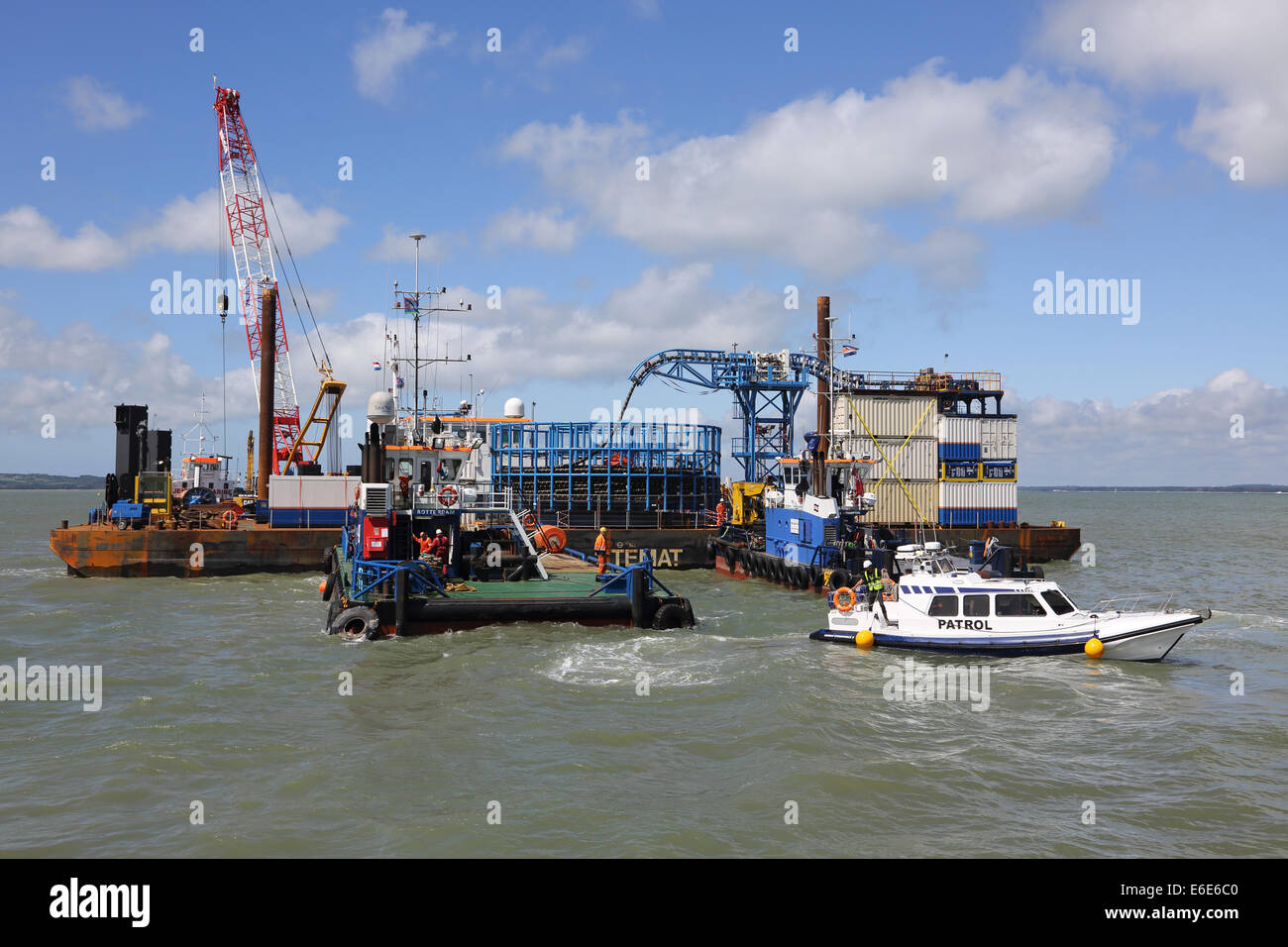 A patrol boat leaves an offshore marine cable laying operation in the Solent, UK. Stock Photo