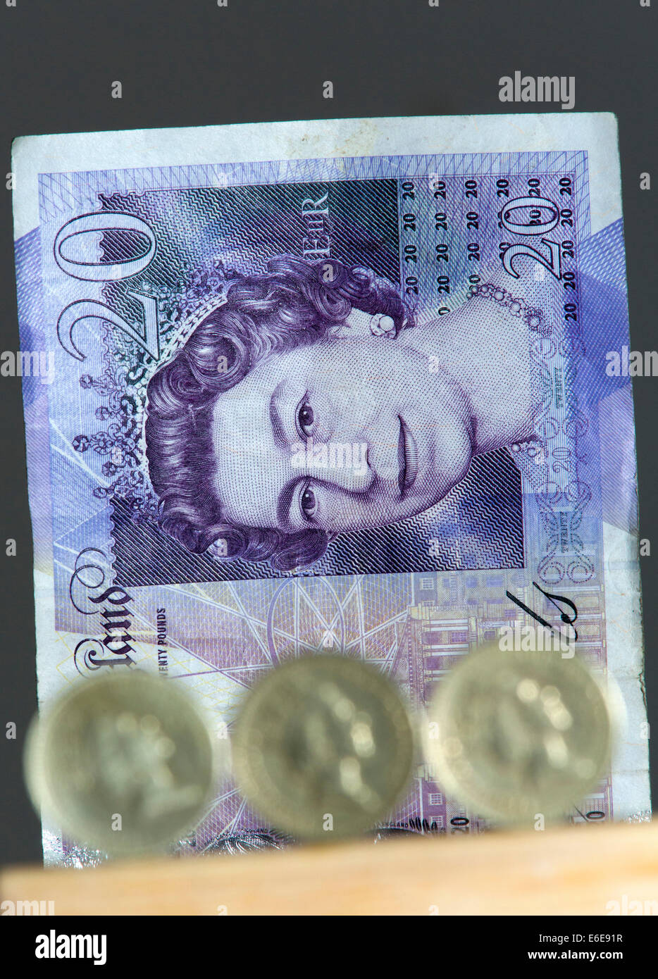 £1 British Stirling coins are pictured in front of a £20 British ...