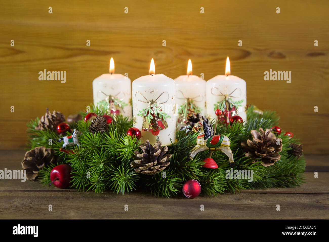 Natural advent wreath or crown with four burning white candles Stock Photo  - Alamy