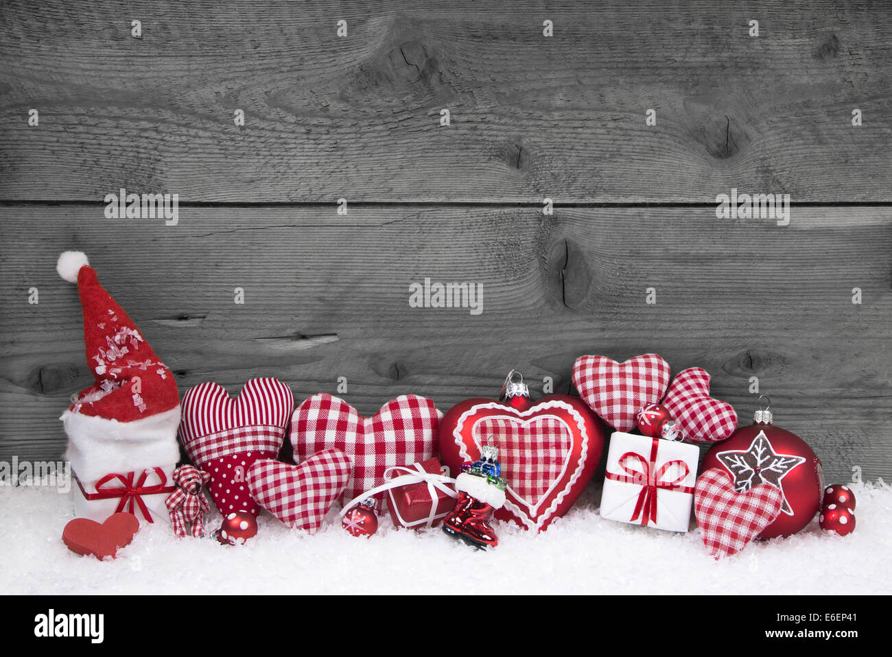 Red white checked christmas decoration on grey wooden shabby background. Stock Photo
