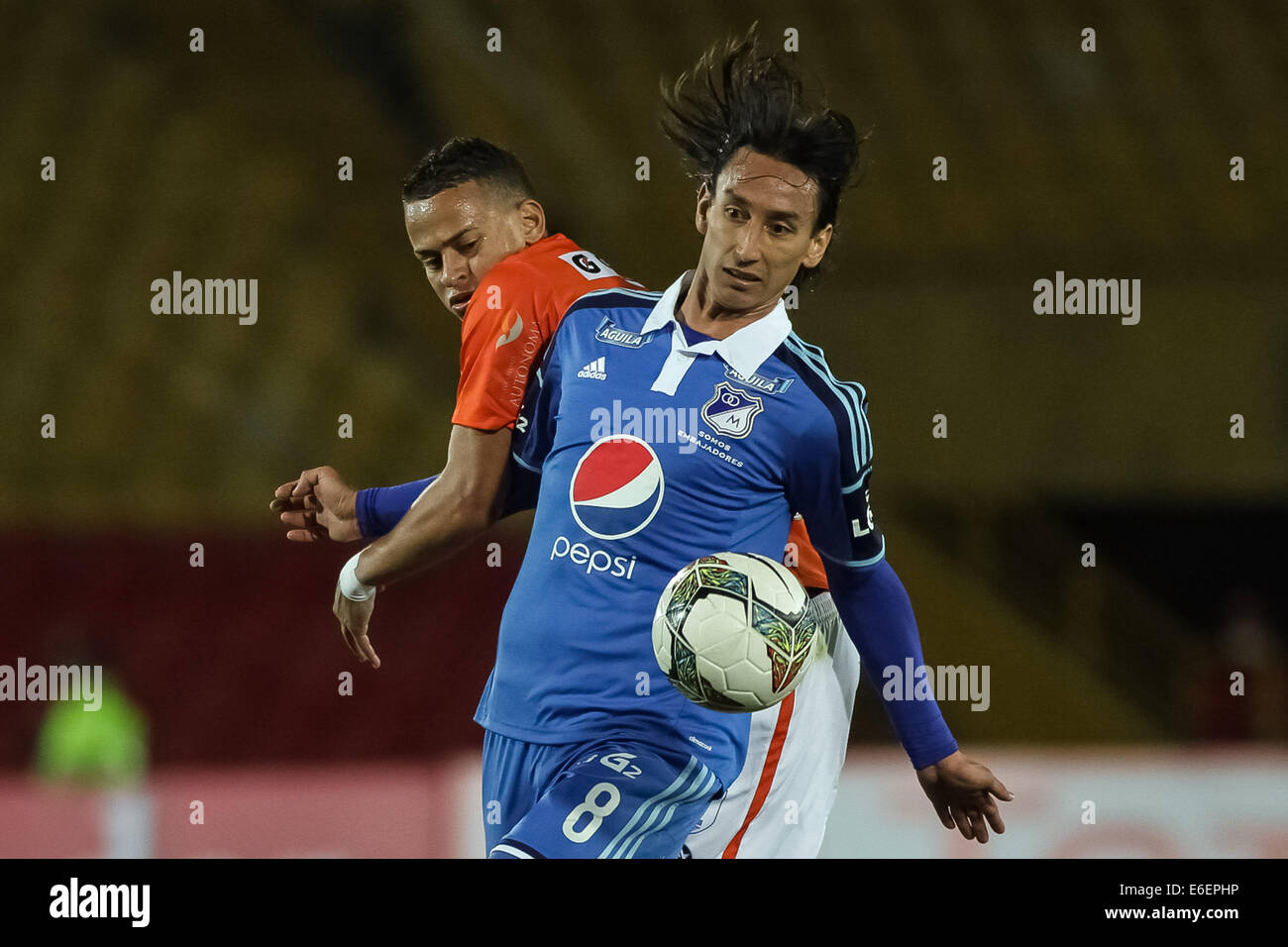Bogota, Colombia. 21st Aug, 2014. Rafael Robayo (Front) of Millonarios of Colombia vies for the ball with Donald Millan (Back), of Cesar Vallejo of Peru, during their match of the South American Cup, in Bogota, capital of Colombia, on Aug. 21, 2014. Credit:  Jhon Paz/Xinhua/Alamy Live News Stock Photo