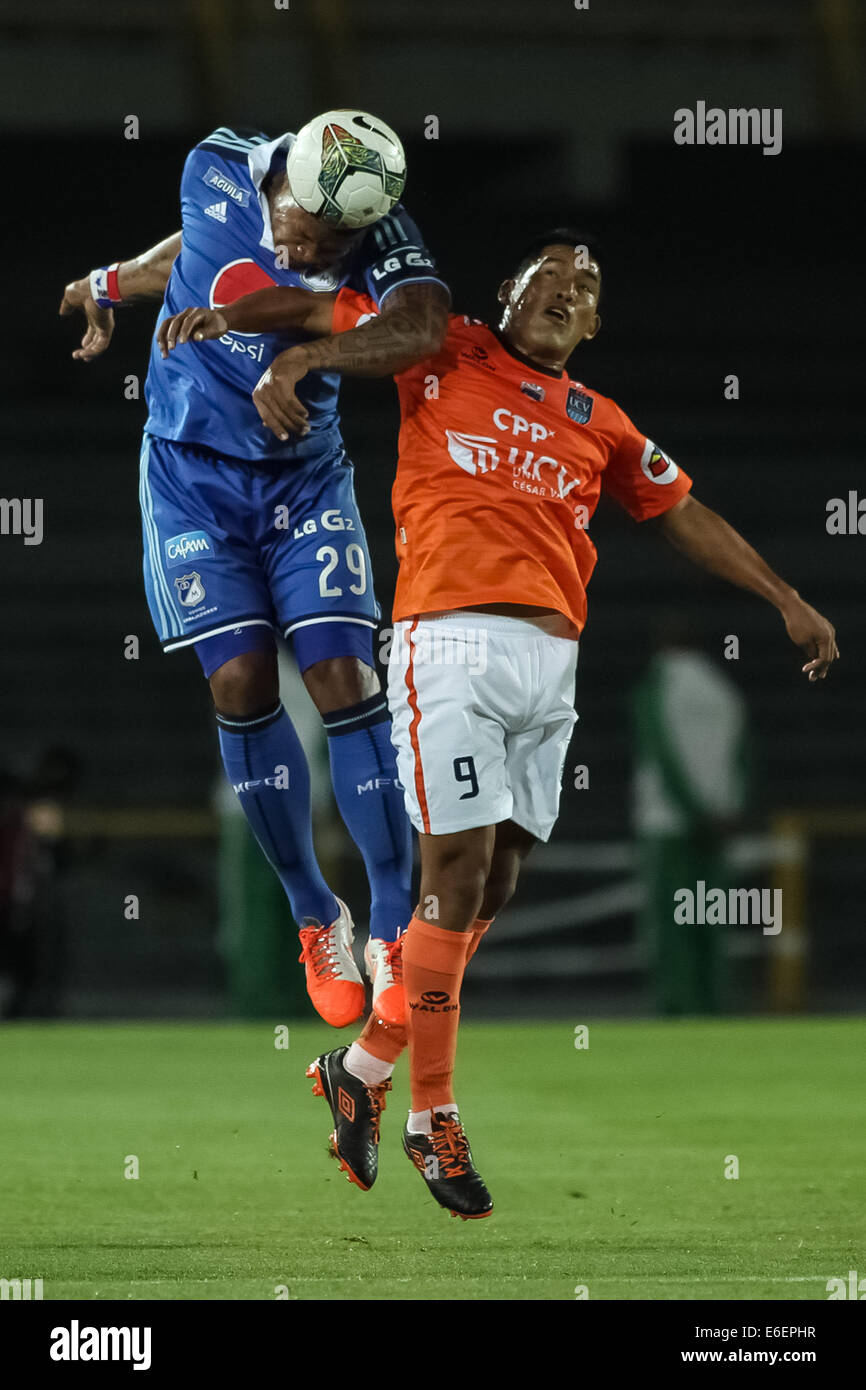 Bogota, Colombia. 21st Aug, 2014. Roman Torres (L) of Millonarios of Colombia vies for the ball with Andy Pando (R) of Cesar Vallejo of Peru, during their match of the South American Cup, in Bogota, capital of Colombia, on Aug. 21, 2014. Credit:  Jhon Paz/Xinhua/Alamy Live News Stock Photo