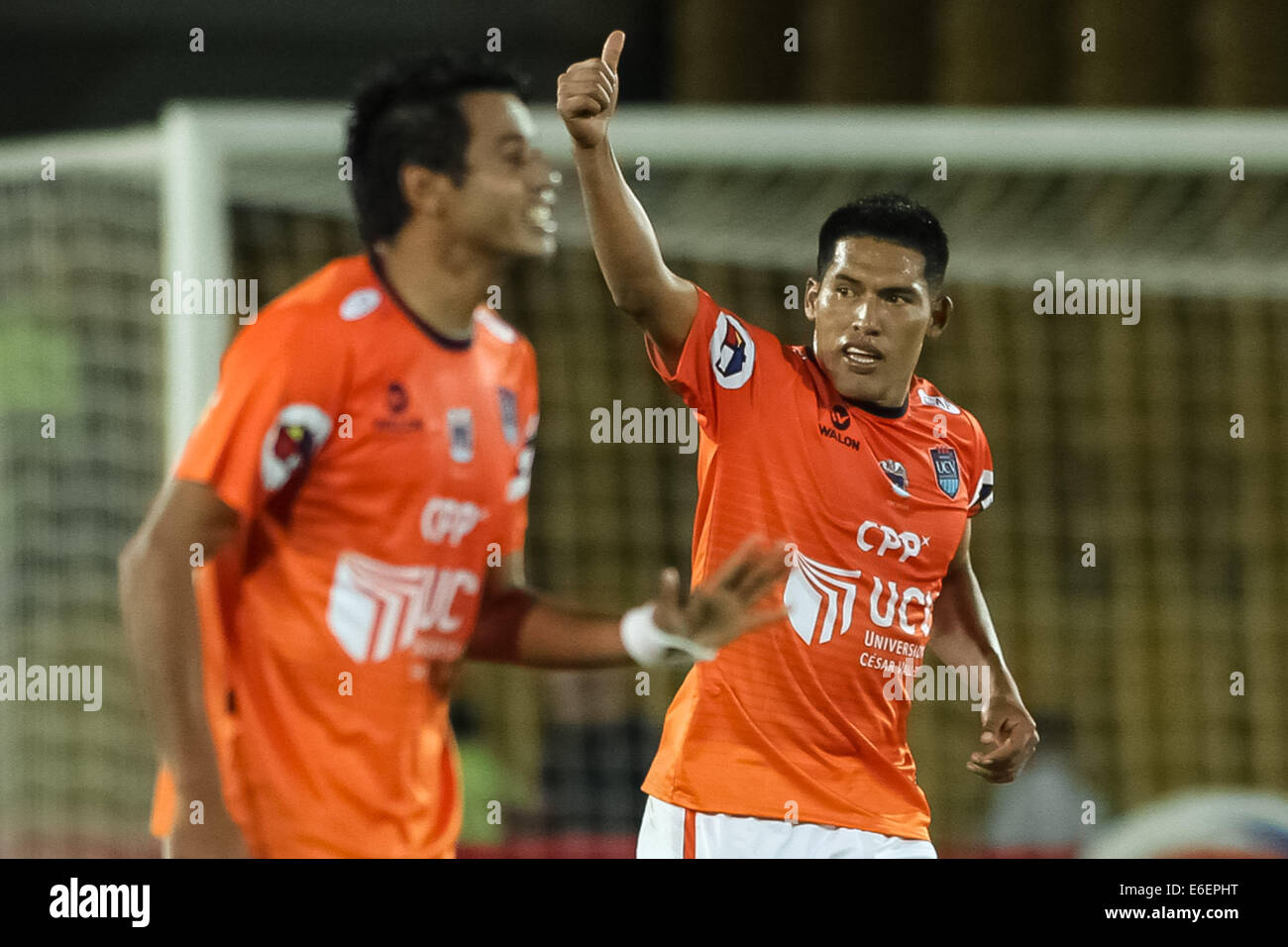 Bogota, Colombia. 21st Aug, 2014. Andy Pando (R), of Cesar Vallejo of Peru celebrates after scoring during the match of the South American Cup, against Millonarios of Colombia, in Bogota, capital of Colombia, on Aug. 21, 2014. Credit:  Jhon Paz/Xinhua/Alamy Live News Stock Photo