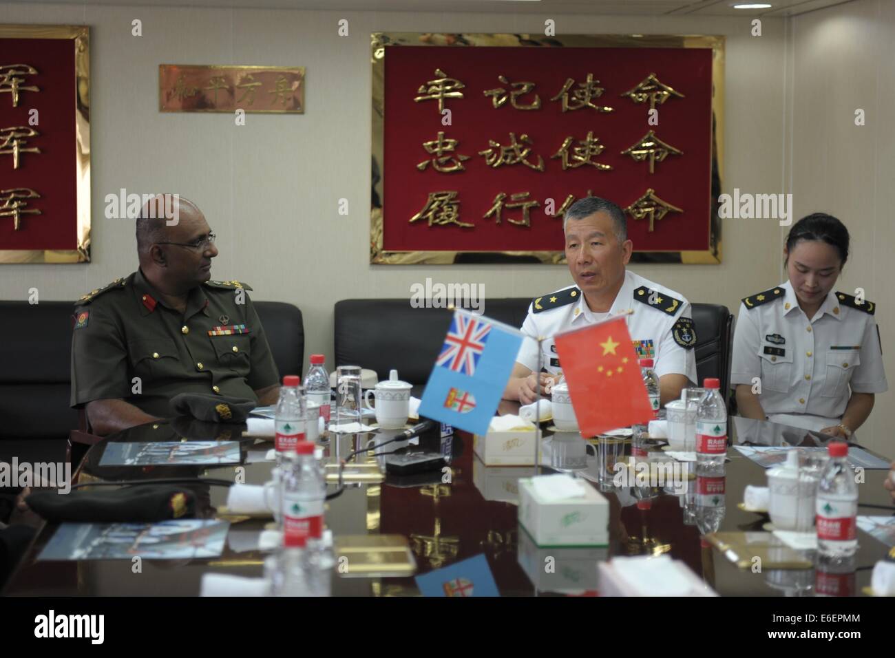 Suva, Fiji. 22nd Aug, 2014. Shen Hao (C), deputy commander of the East China Sea Fleet of the Chinese Navy and commander of 'Mission Harmony-2014', meets with Brig. Gen. Mohammed Aziz (L), chief-of-staff of the Republic of Fiji Military Forces in Suva, Fiji, Aug. 22, 2014. Peace Ark, hospital ship of China's People's Liberation Army Navy, arrived at the Fijian capital of Suva on Friday, kicking off its week-long medical assistance mission in the South Pacific island country. Credit:  Michael Yang/Xinhua/Alamy Live News Stock Photo